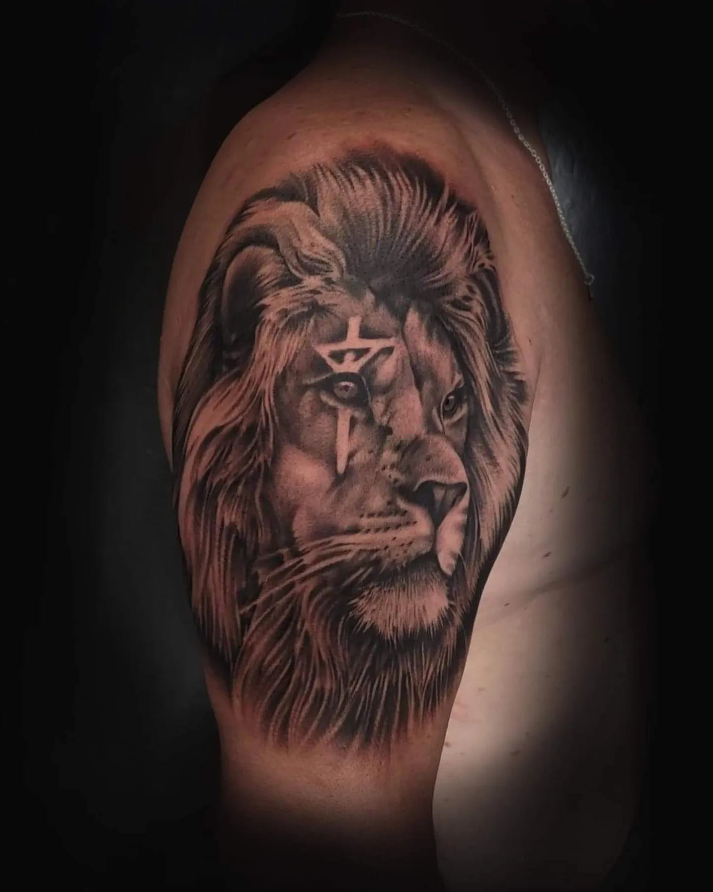 Lion realism tattoo on the shoulder by Mark Melanson