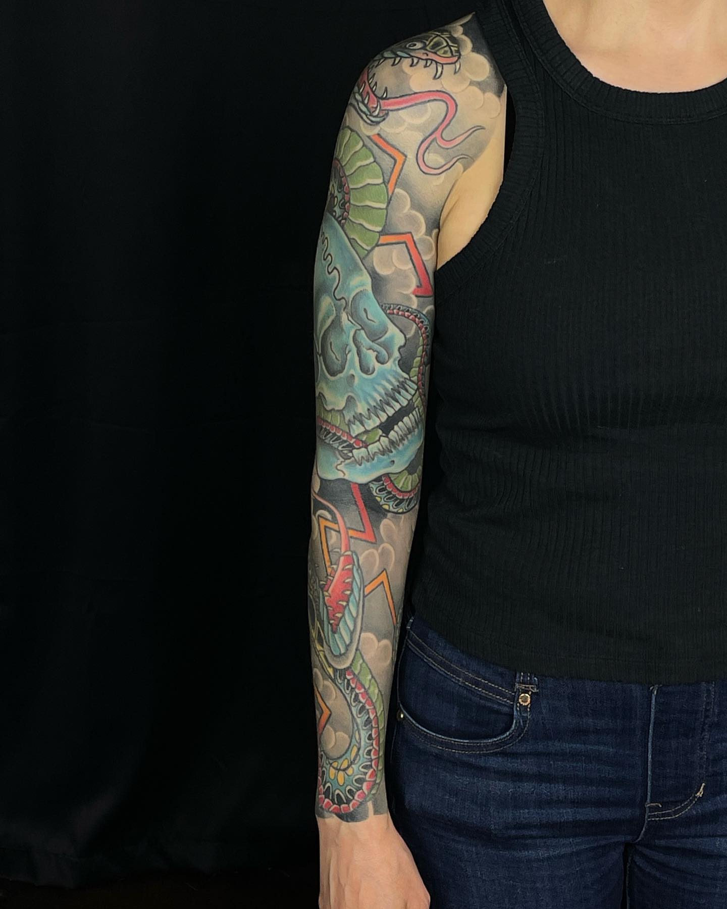 Skull and snake American traditional tattoo on the upper arm by Mark Thompson, Dallas, Texas