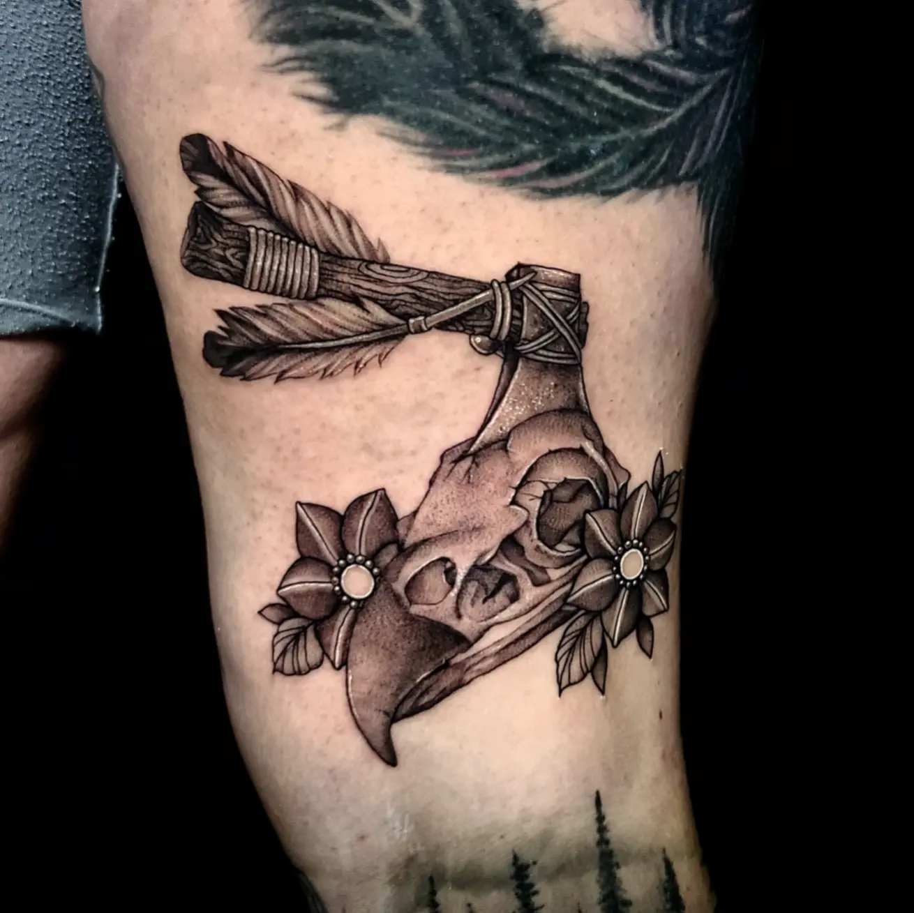 Deer skull with feathers and flowers realism tattoo on the forearm by Sydney Paige, Mentor, Ohio