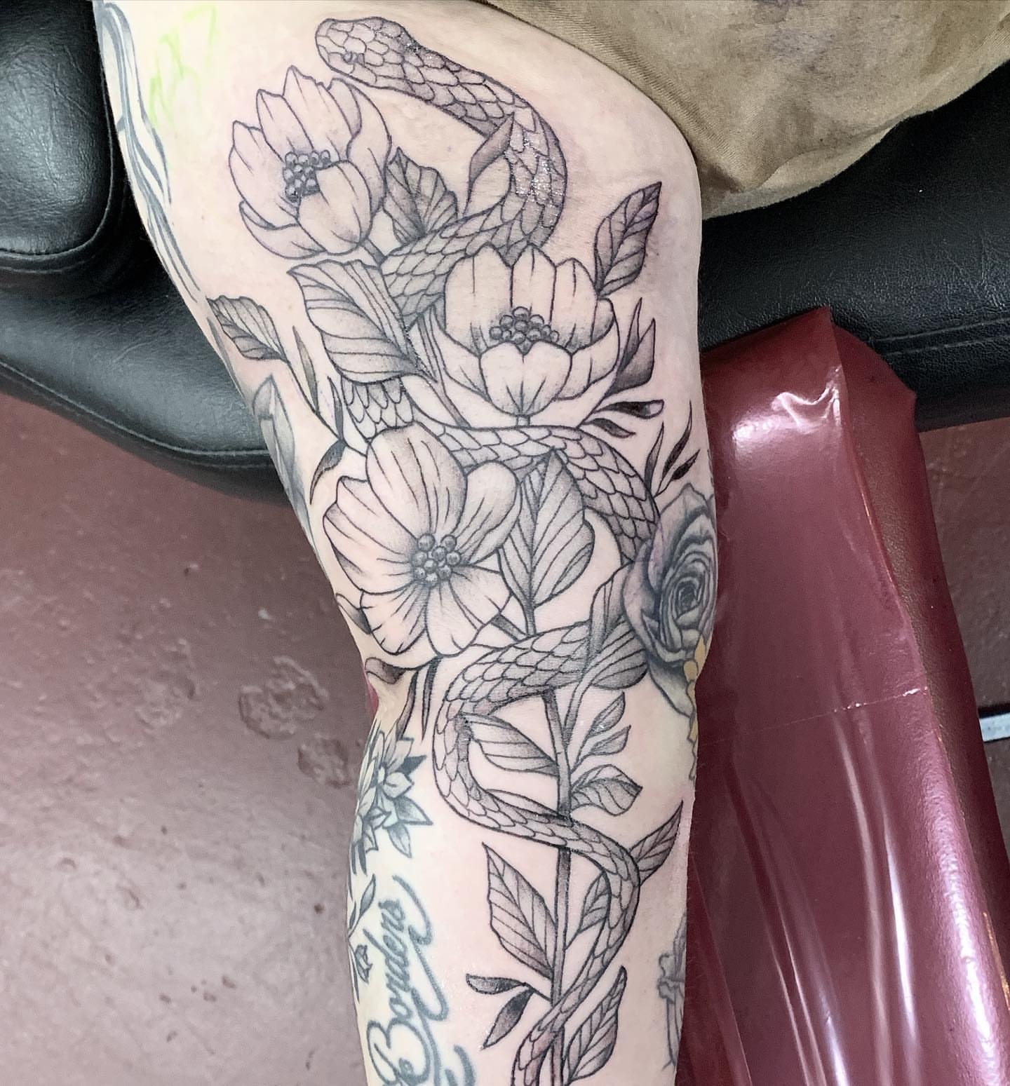 Snake and flowers black and grey tattoo on the forearm by IdleHandsFlex, New Orleans, Louisiana