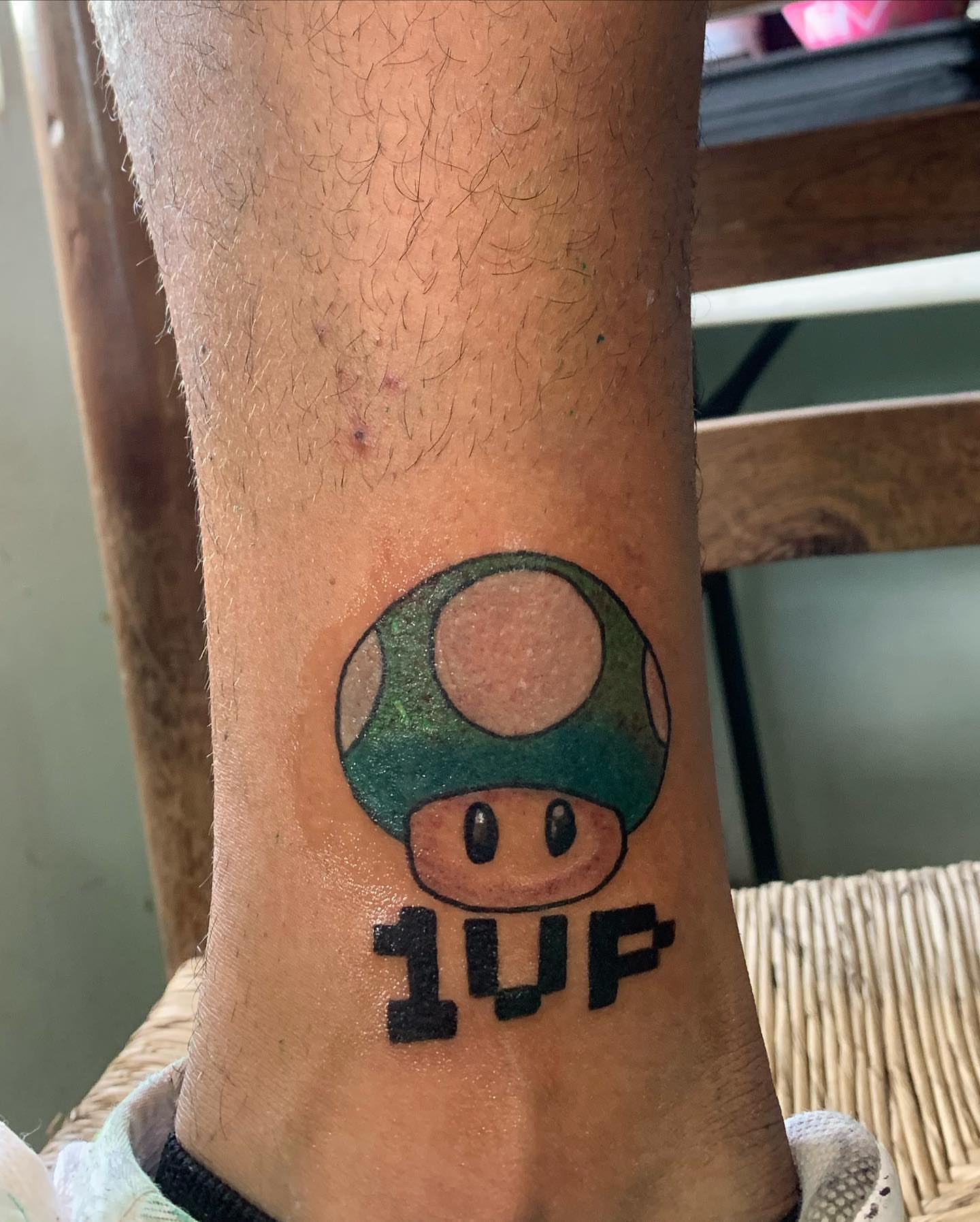 Green mushroom dotwork tattoo on the forearm by El Zepa