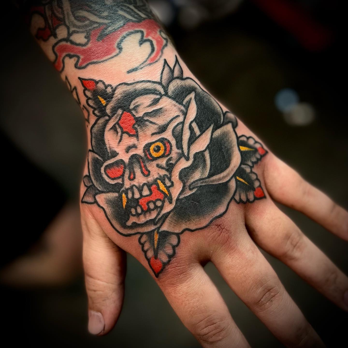 Skull and rose American traditional tattoo on the hand by Troy Mort, Altoona, Pennsylvania