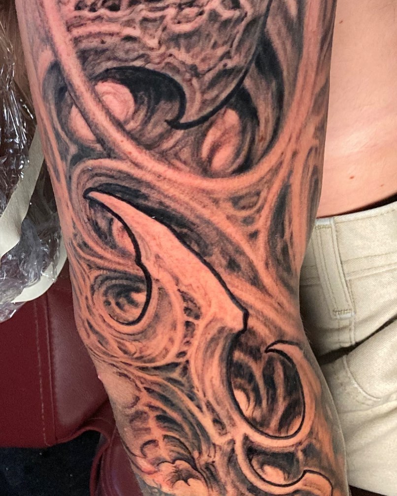 Abstract swirls black and grey tattoo on the forearm by Jason Wheelwright