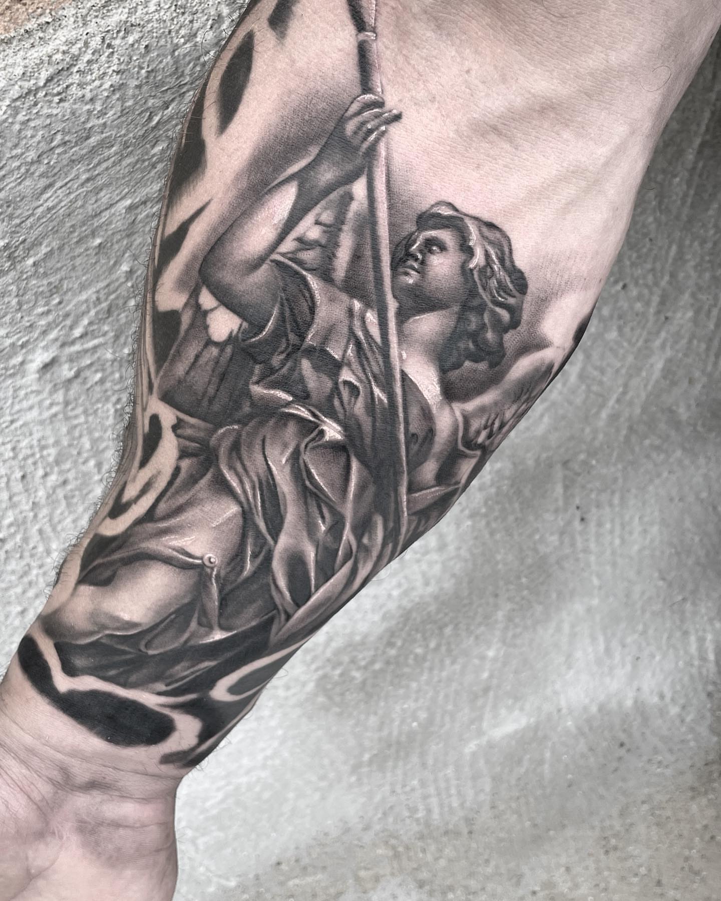 Religious figure realism tattoo on the forearm by mike hudson