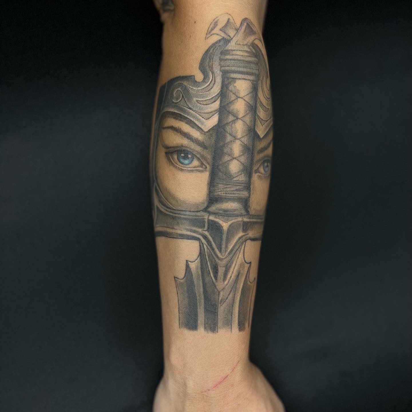 Helmeted warrior realism tattoo on the forearm by Daphne Landry