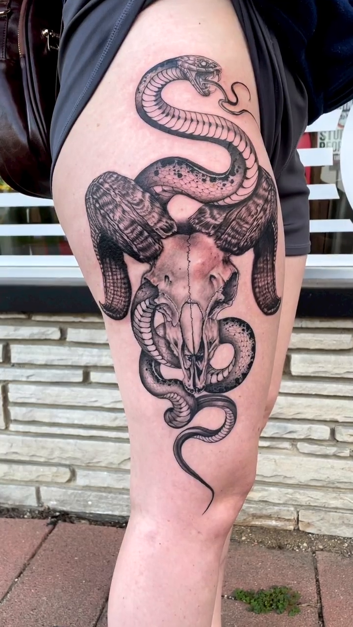 Ram skull with snake dark realism tattoo by Charlie