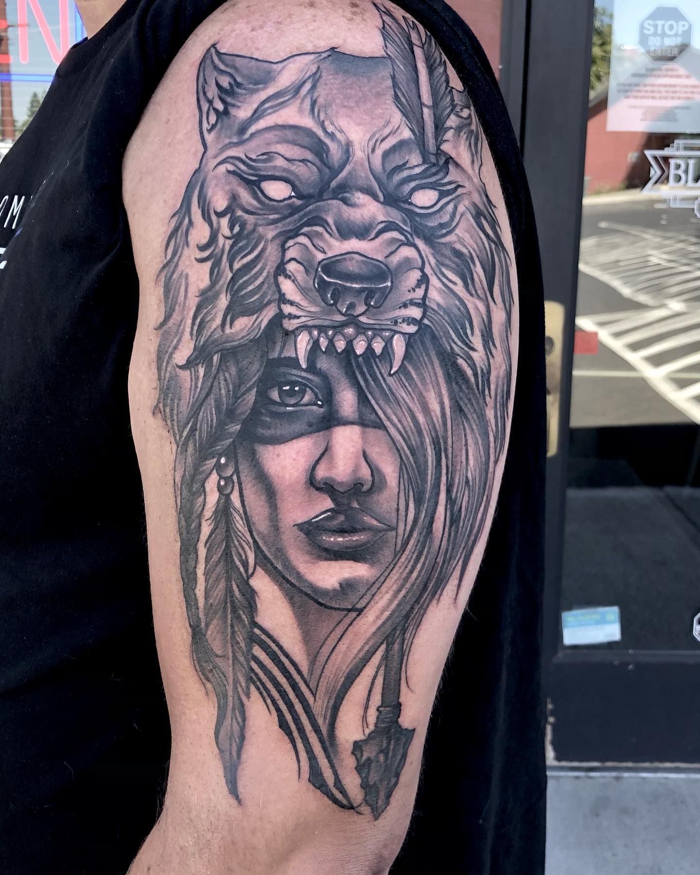 Wolf and woman realism tattoo on the forearm by Aaron Borden