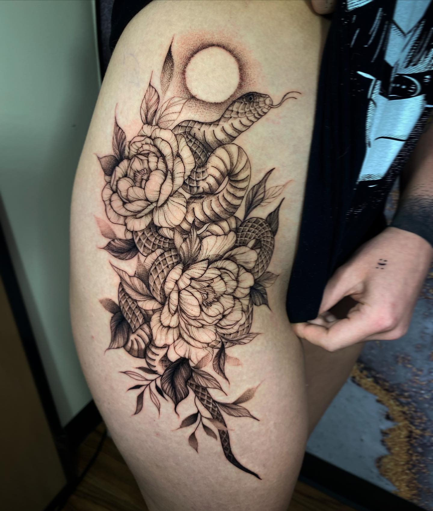 Snake and peony dotwork tattoo on the thigh by Cindy Xu