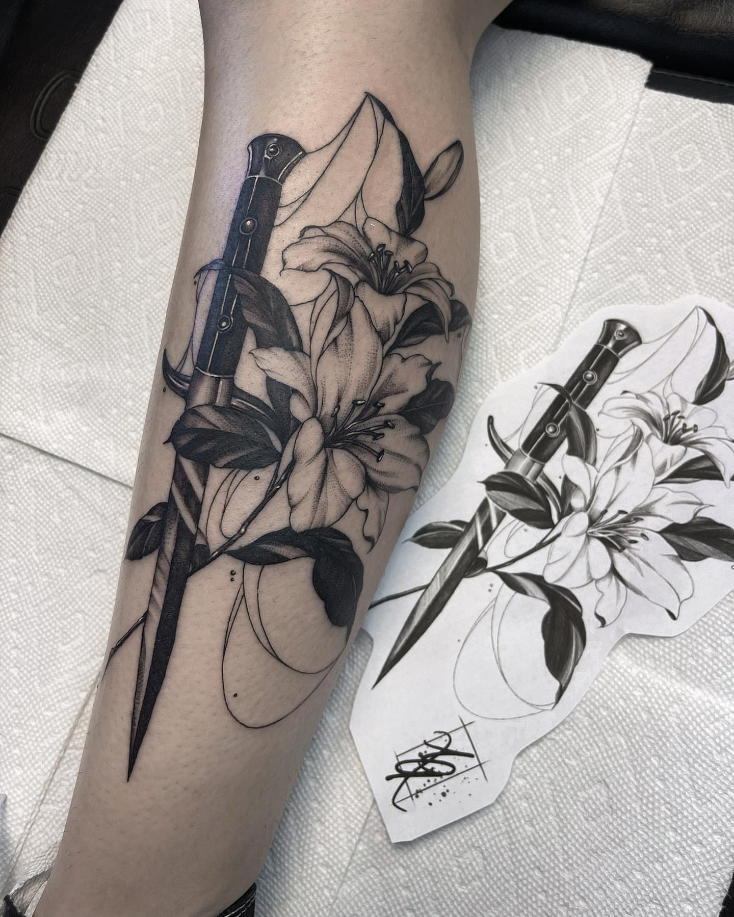 Knife and lilies realism tattoo on the forearm by 𝐀𝐘𝐀𝐍𝐀𝐇