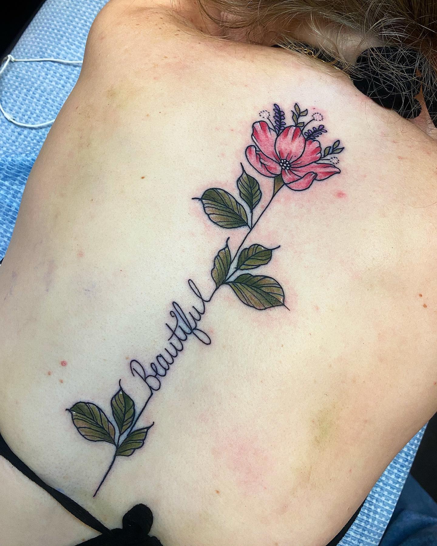 Flower and script new school tattoo on the shoulder by Diana Kunz