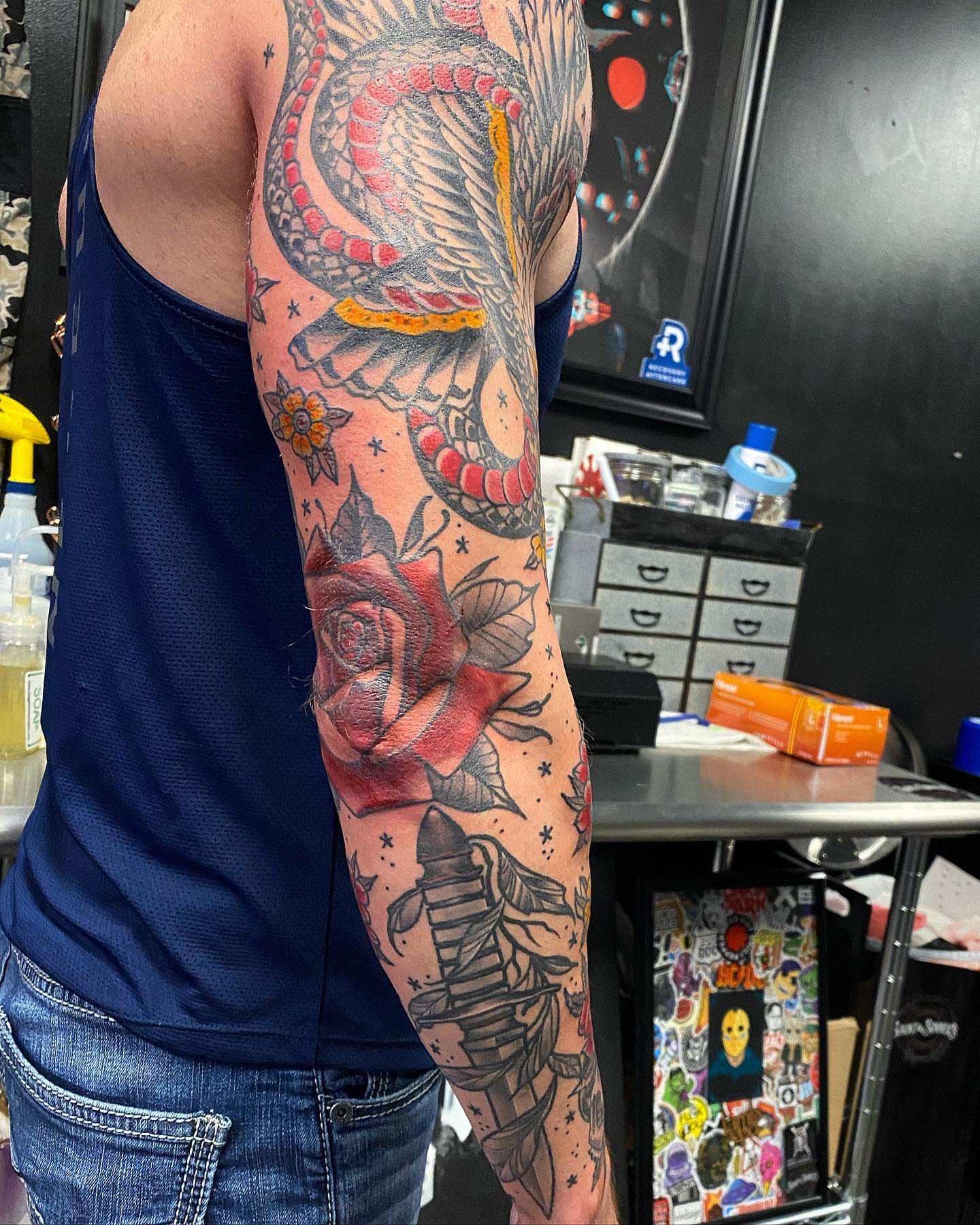 Snake and rose American traditional tattoo on the upper arm by Josh St.germain