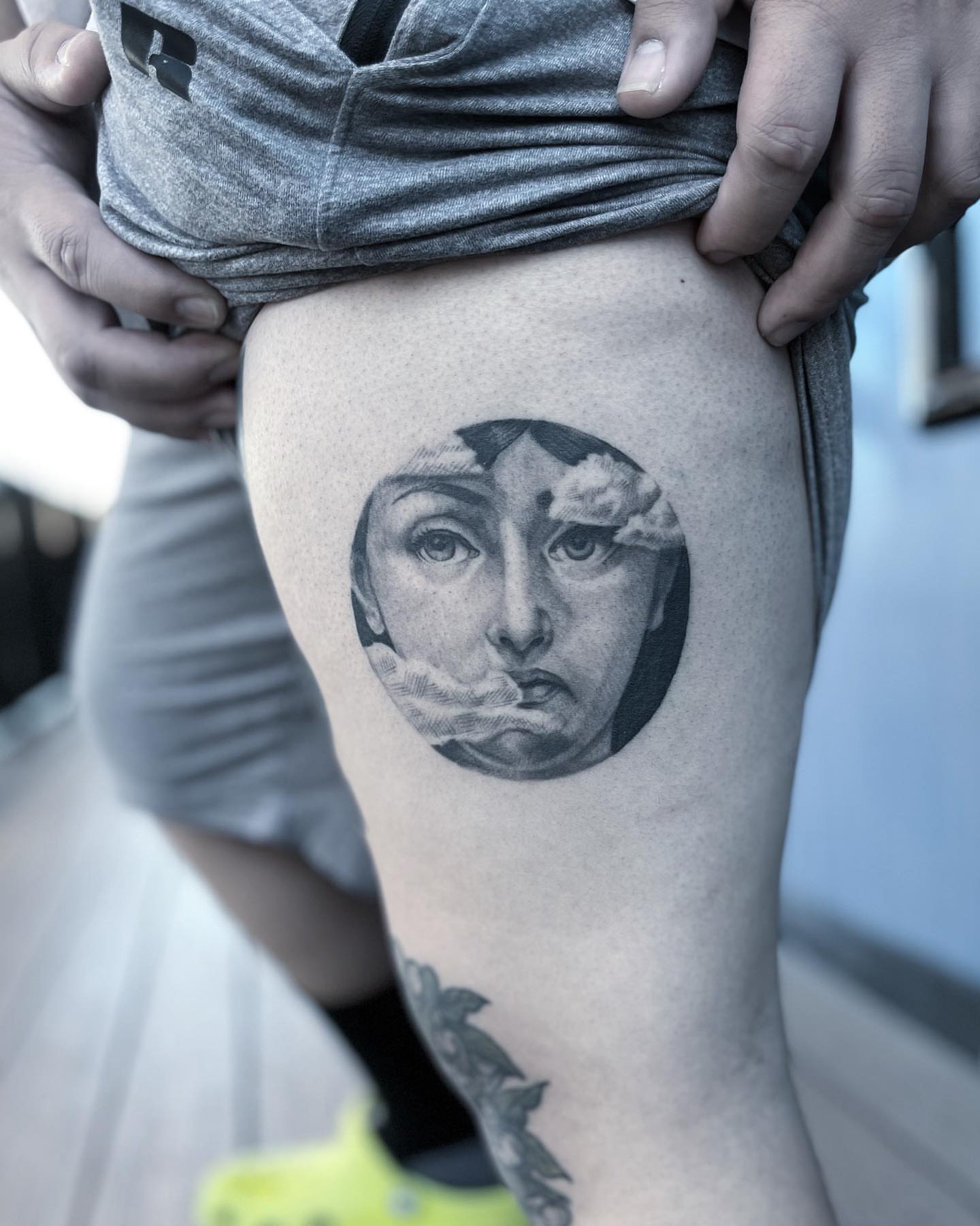 Abstract face dotwork tattoo on the thigh by Neri Gersaint
