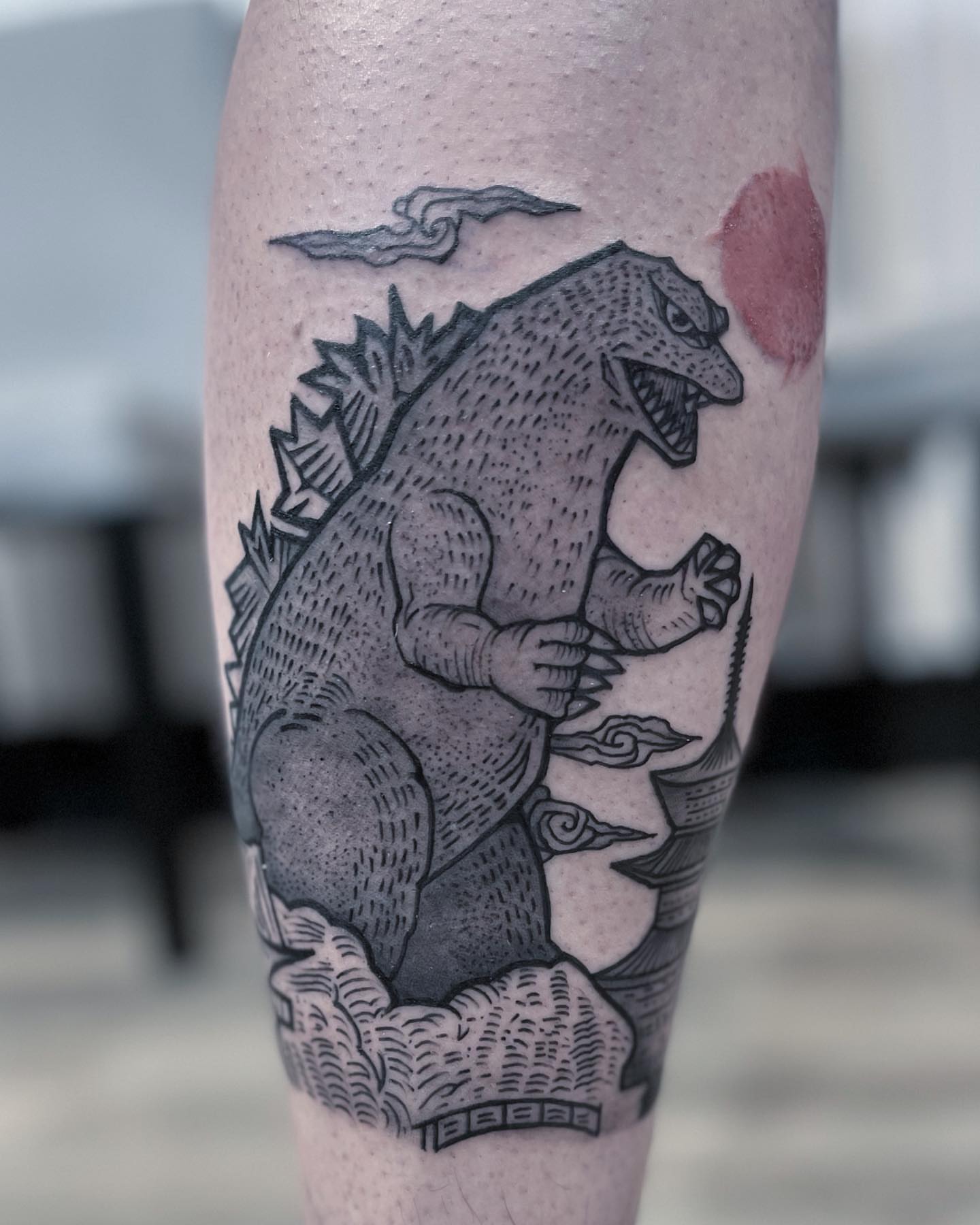 Godzilla black and grey tattoo on the forearm by Neri Gersaint