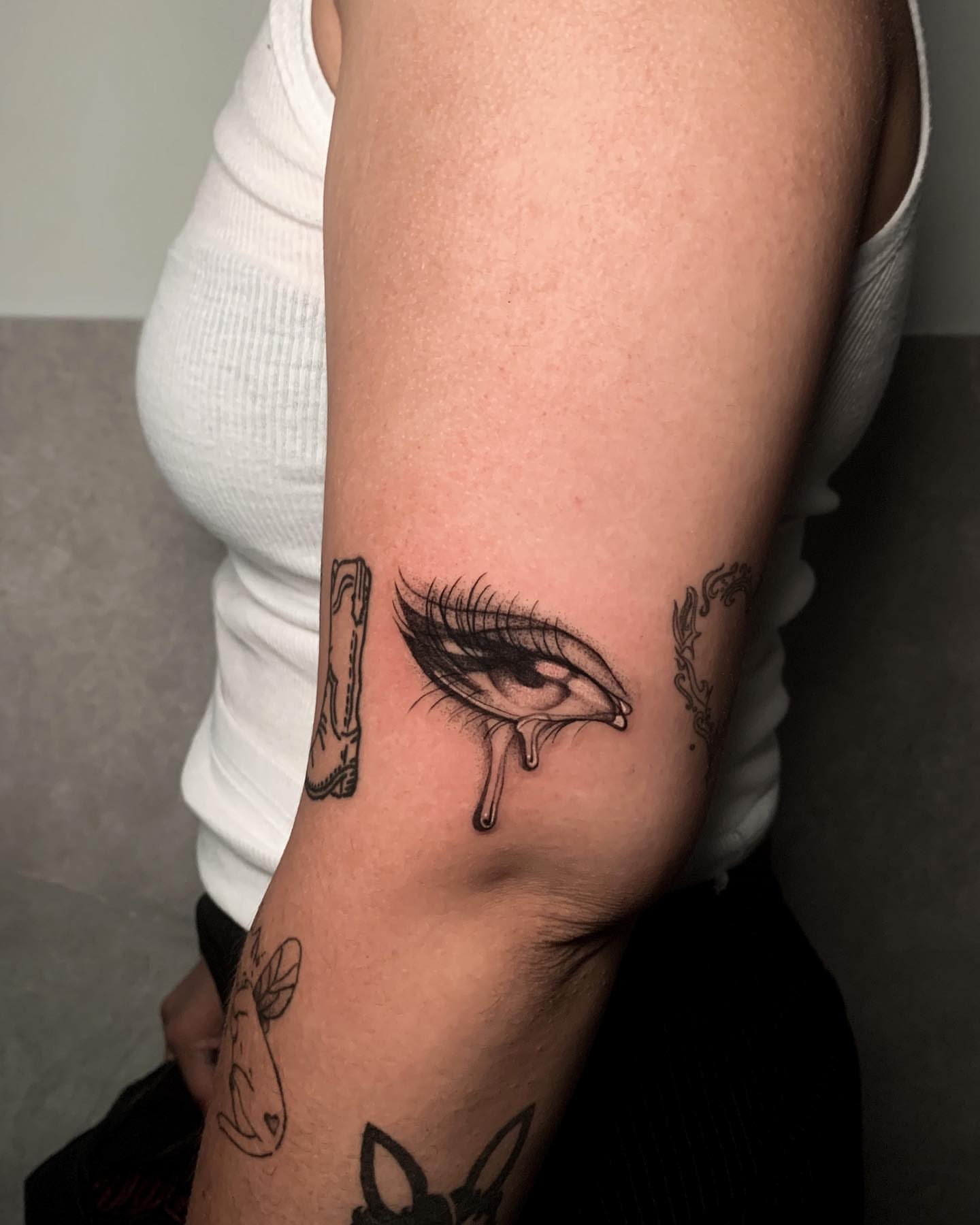 Tear drop black and grey tattoo on the forearm by Priscila, Los Angeles, California