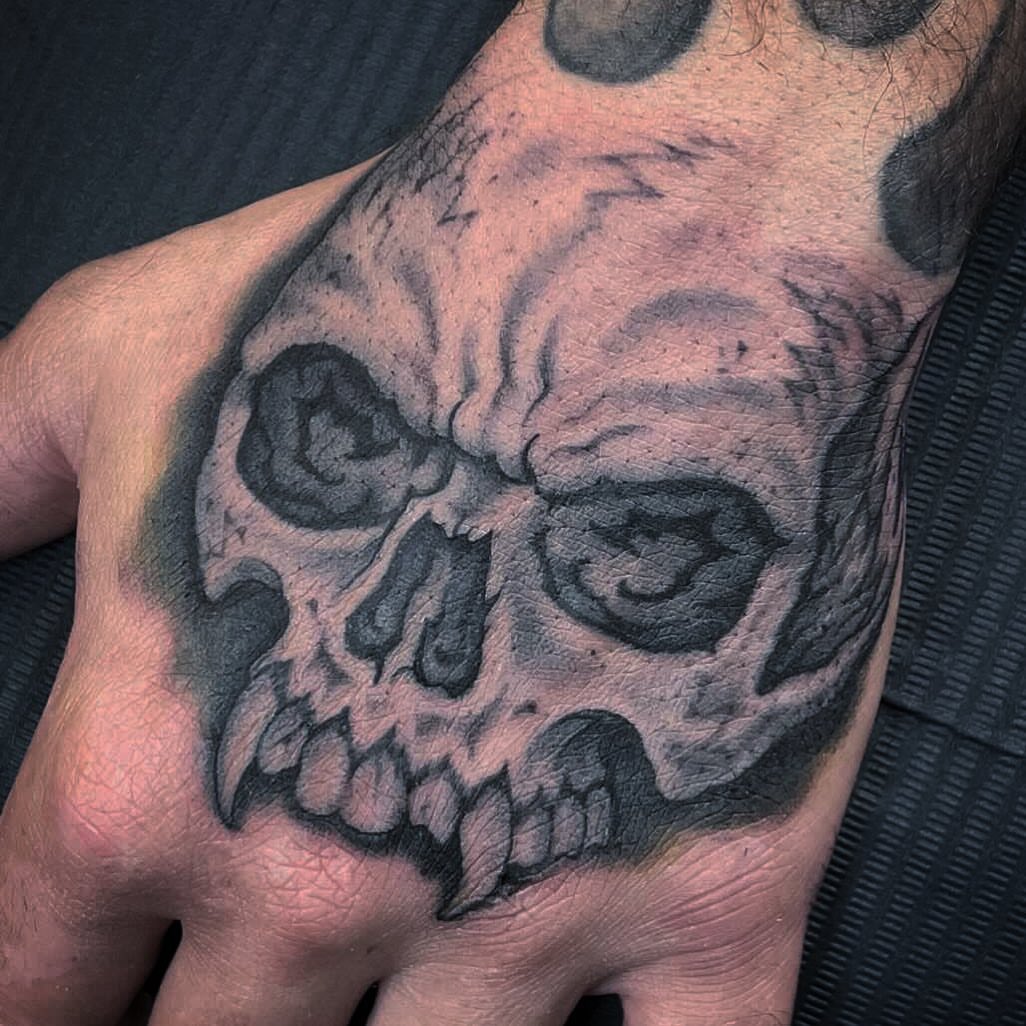 Skull black and grey tattoo on the chest by Bryan Humphries