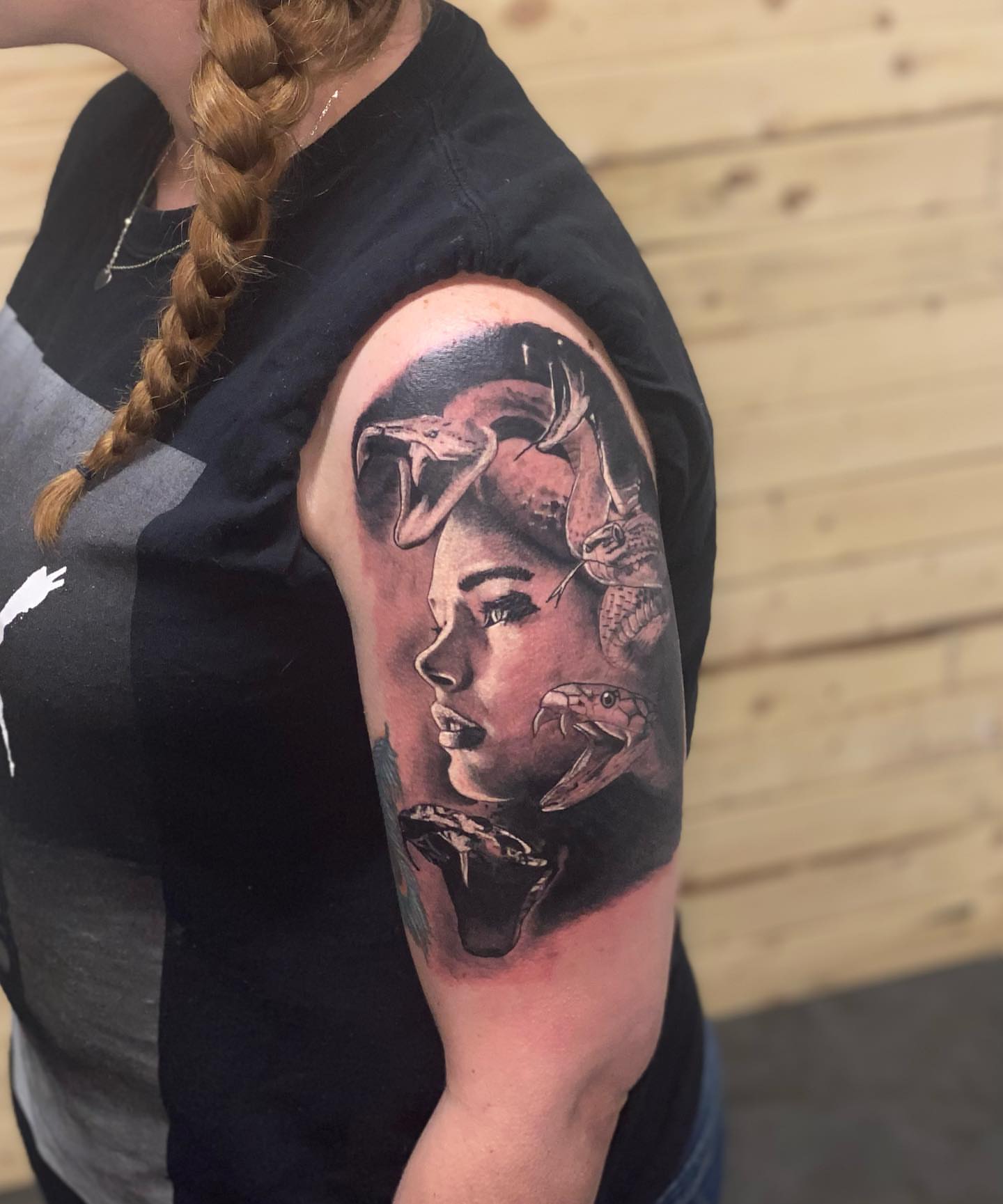 Woman's face with animals realism tattoo on the shoulder by Zach Ashton