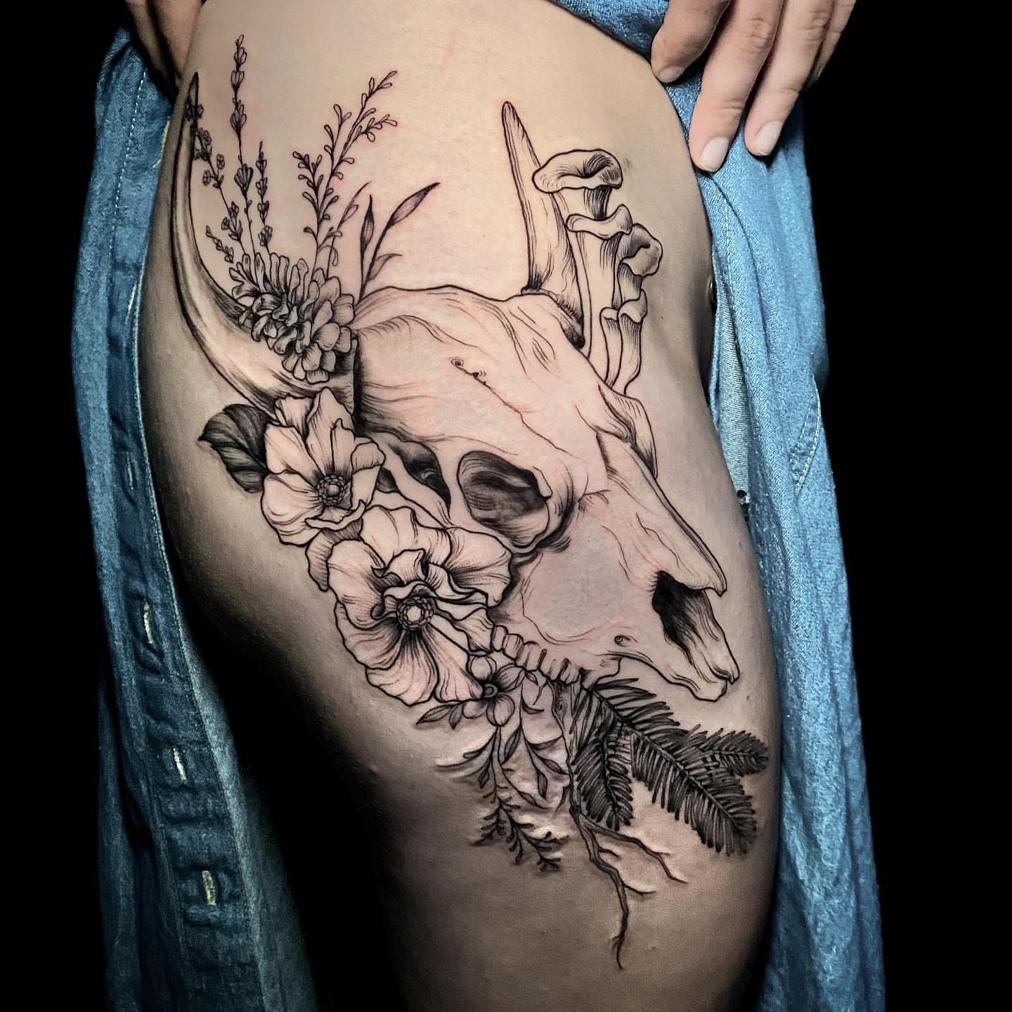 Cow skull with floral elements realism tattoo on the thigh by Caitlin Curtis Tattoos & Booking, Dayton, Ohio