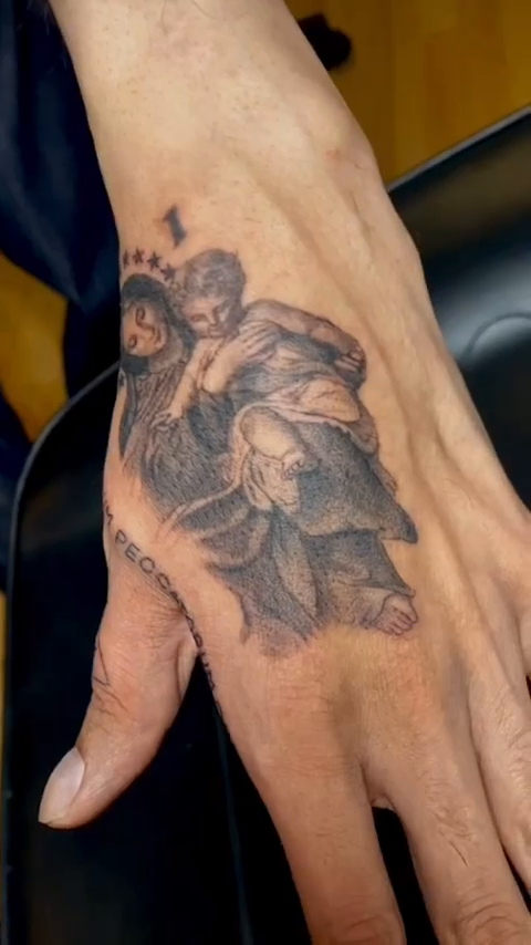 Religious figure with child realism tattoo by Oxana