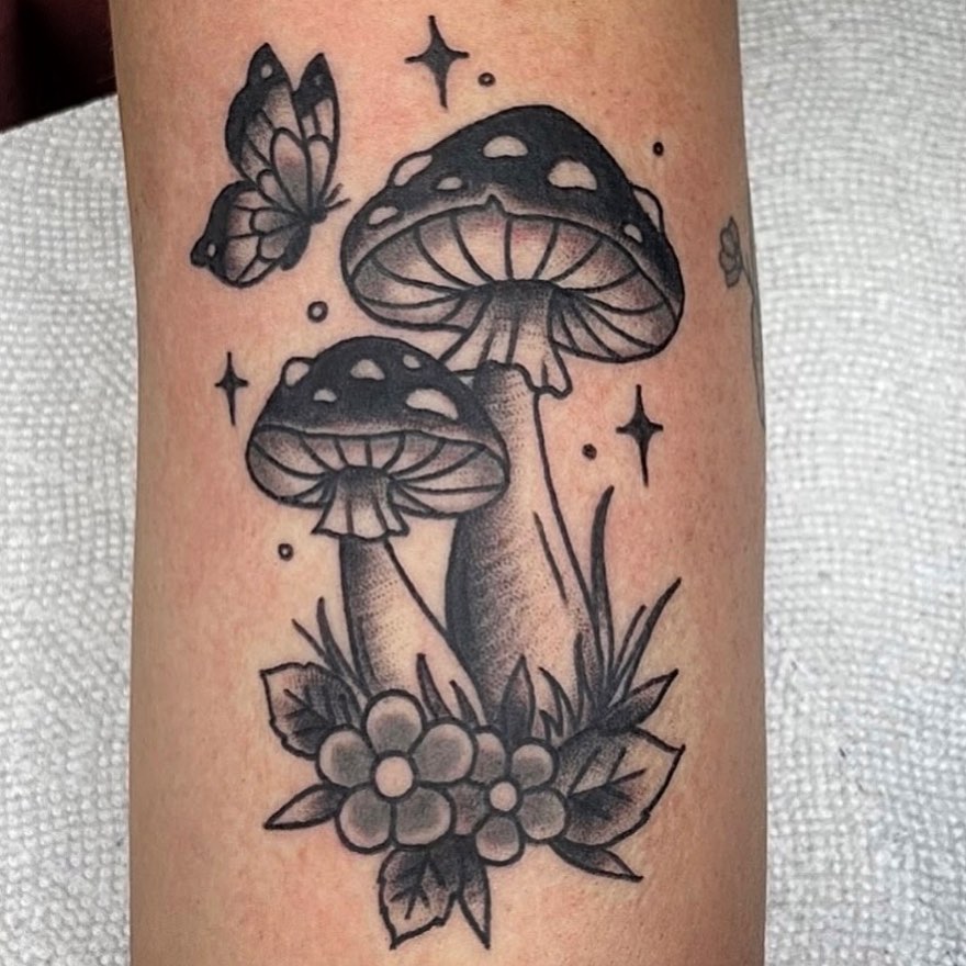 Mushrooms and butterfly black and grey tattoo on the forearm by Danielle Dubois