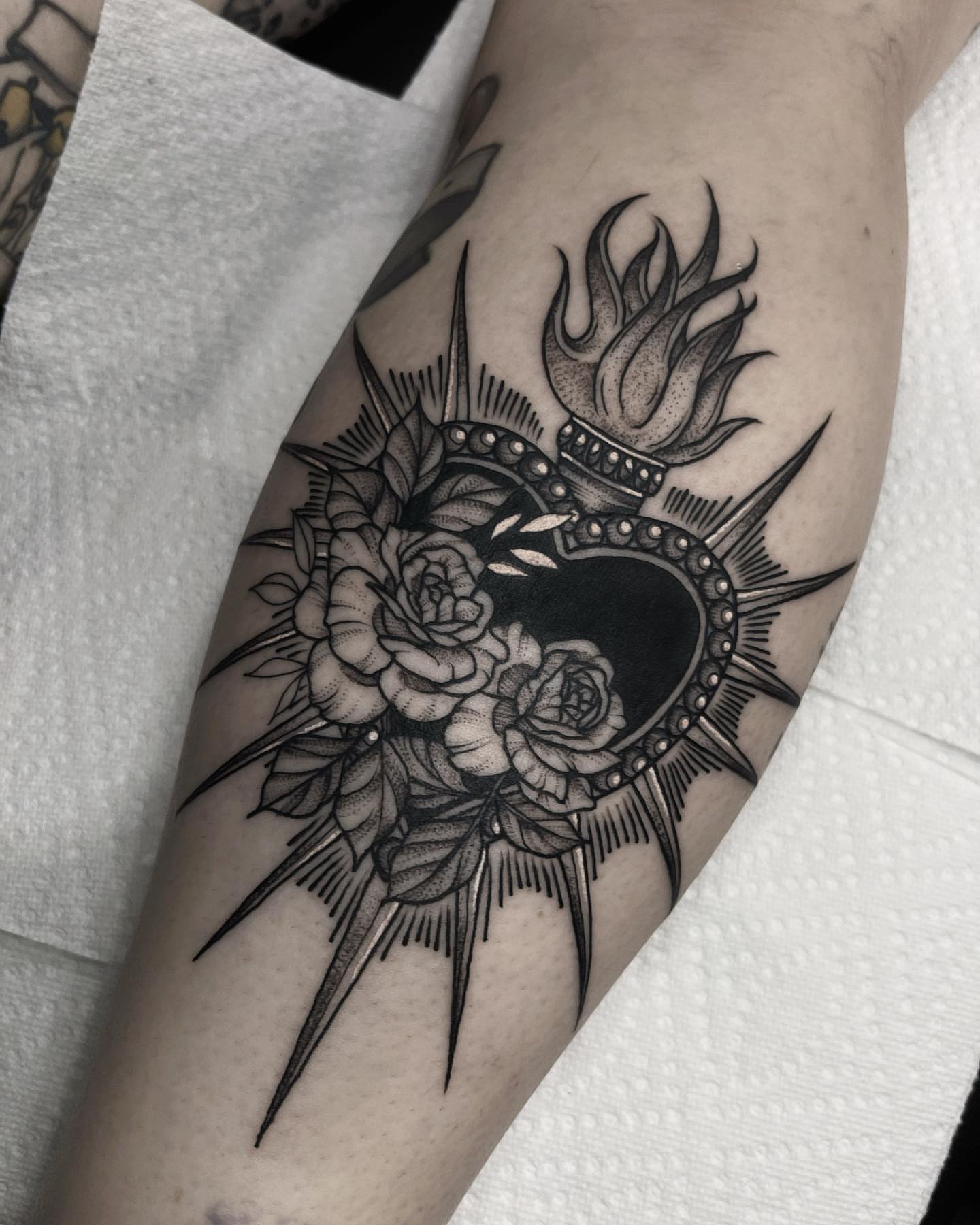 Flame and roses black and grey tattoo on the forearm by 𝐀𝐘𝐀𝐍𝐀𝐇