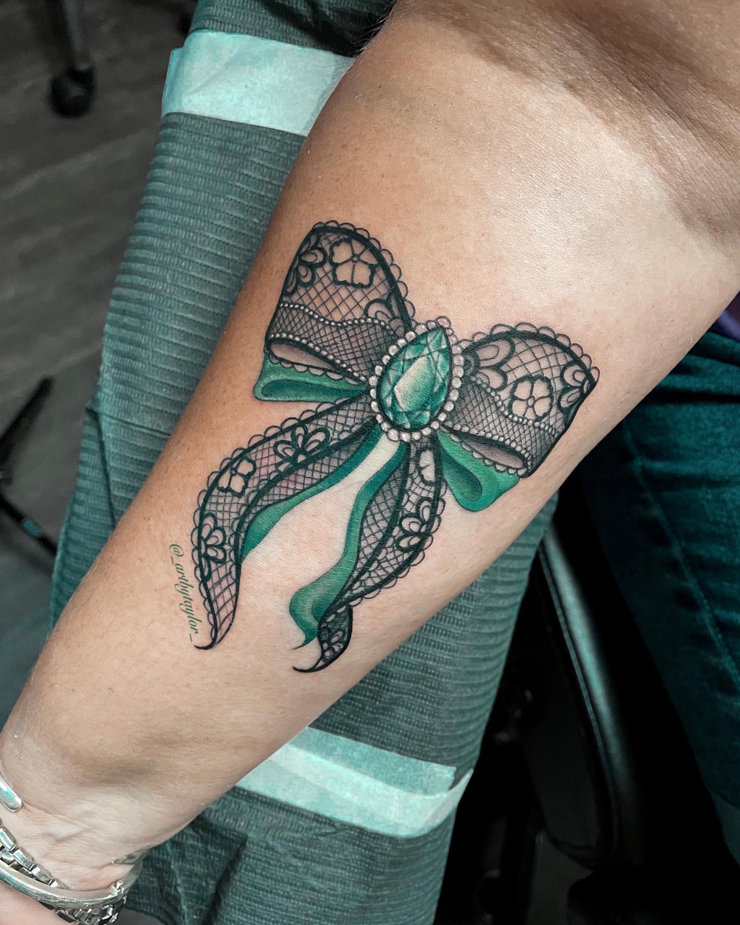 Lacy bow ornamental tattoo on the forearm by Taylor✍🏽️