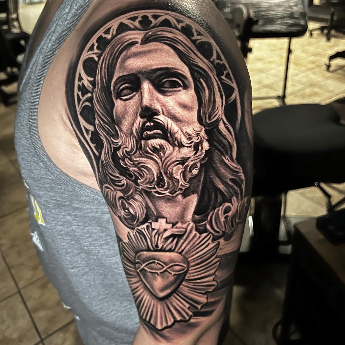 Religious figure realism tattoo on the shoulder by Gary Graves
