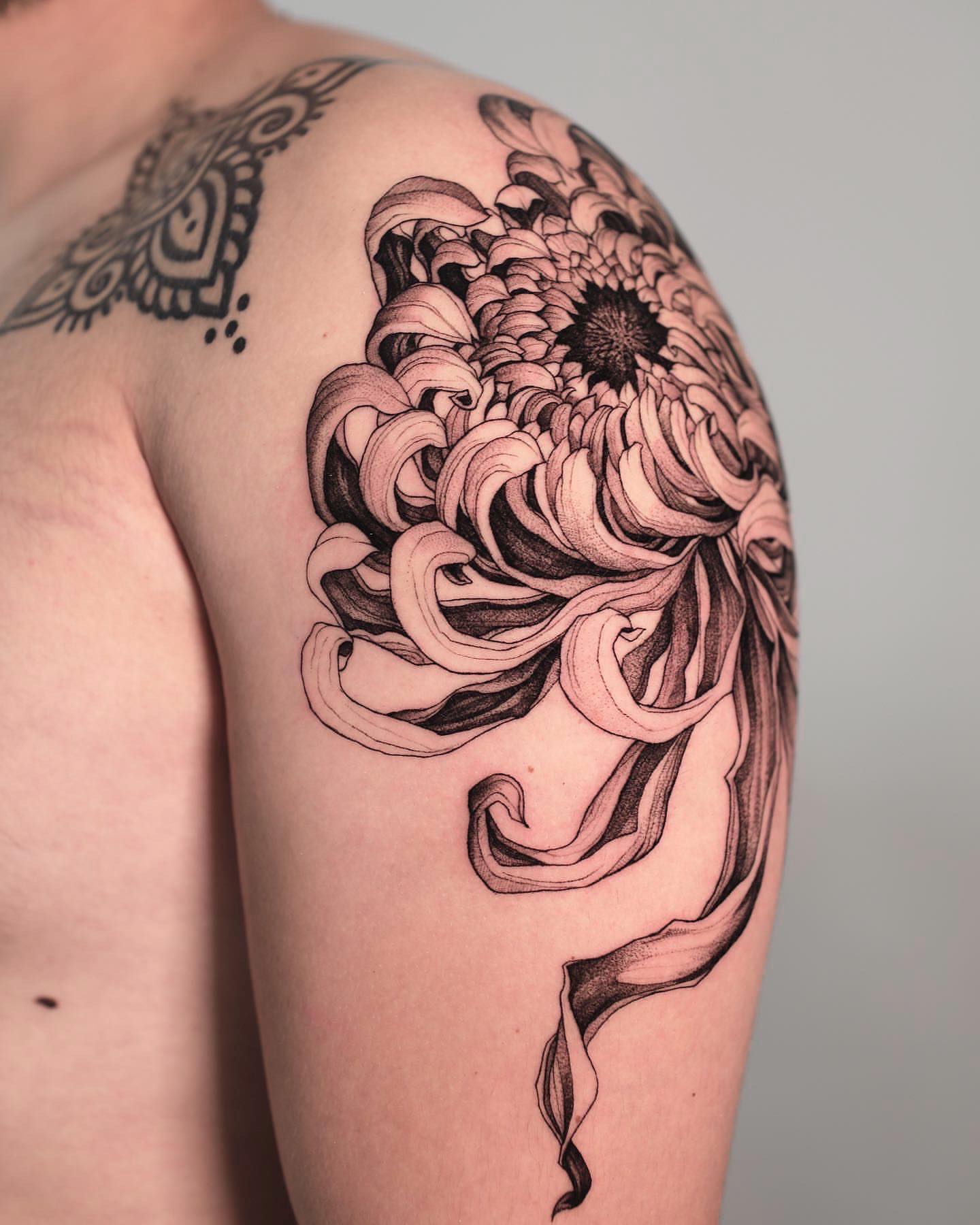 Chrysanthemum black and grey tattoo on the shoulder by Strokin Konstantin
