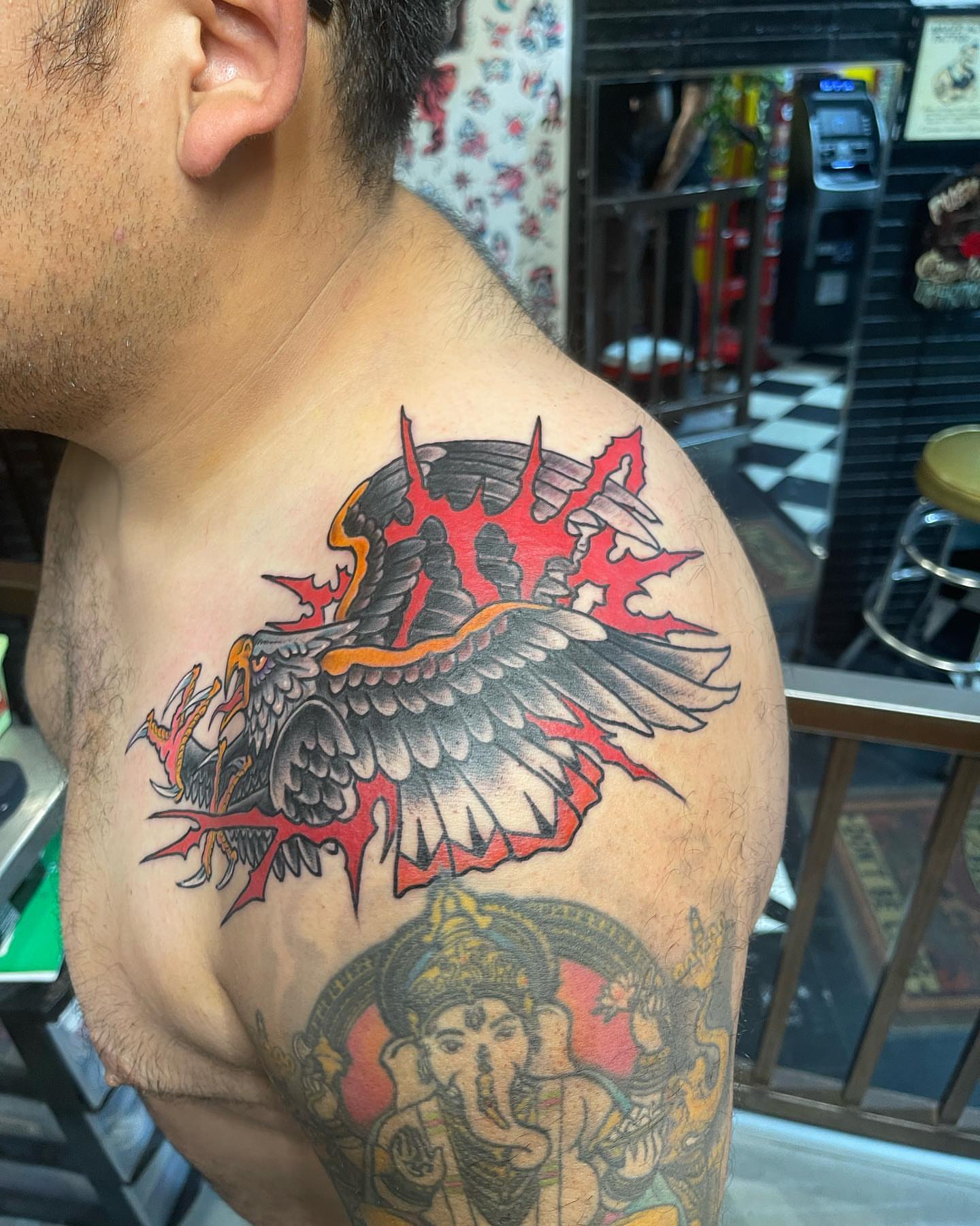 Flaming eagle American traditional tattoo on the shoulder by Edward Choat