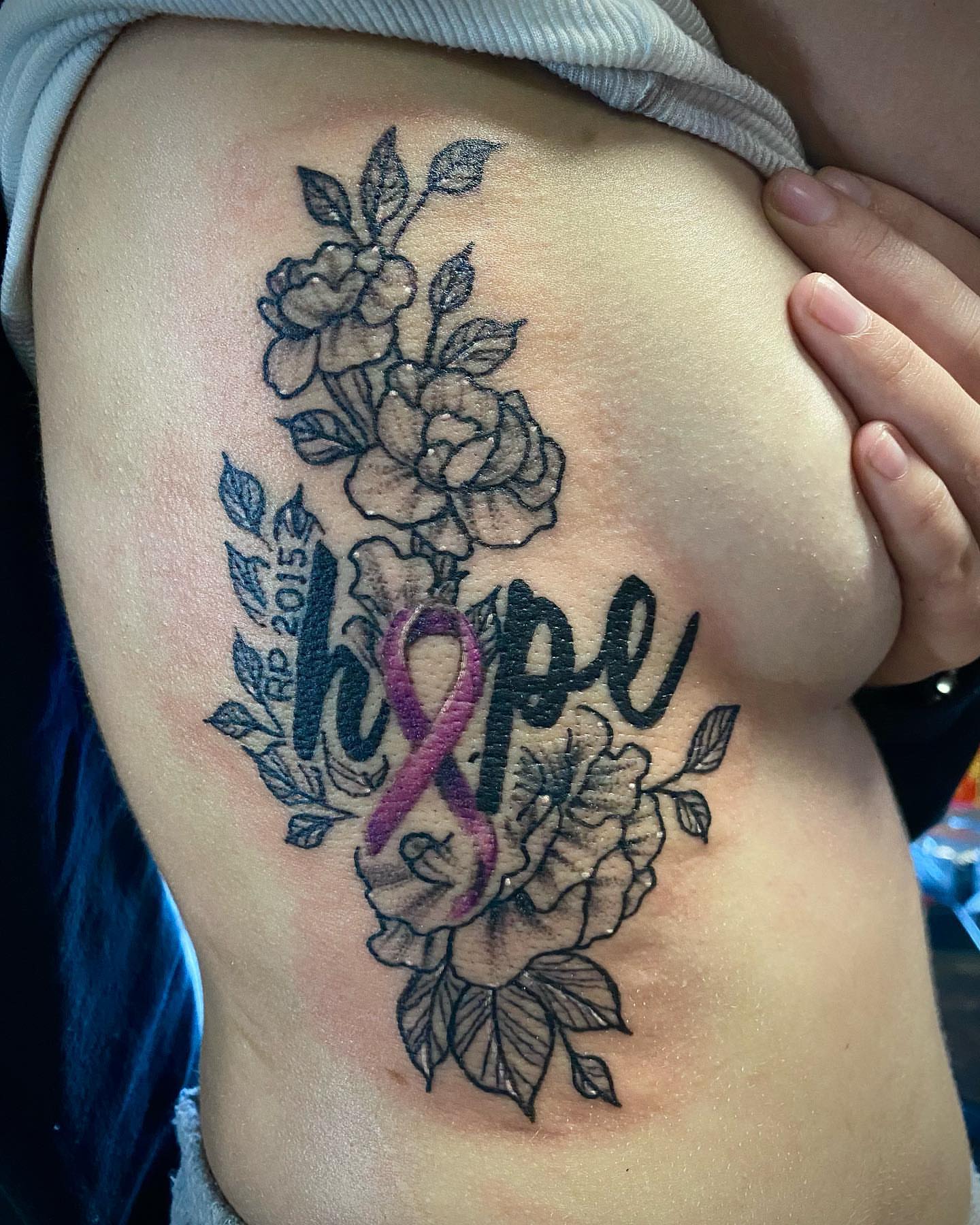 Roses and ribbon black and grey tattoo on the ribs by Josh St.germain