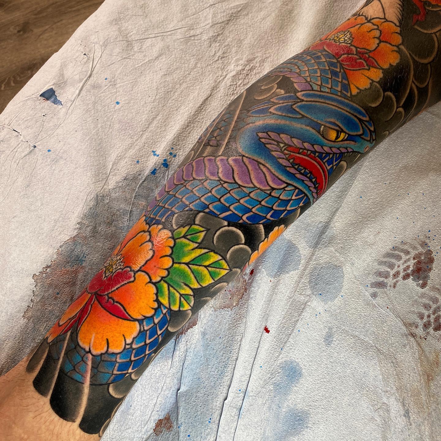 Koi fish and flowers japanese irezumi tattoo on the forearm by Erick Lynch, Cambridge, Massachusetts