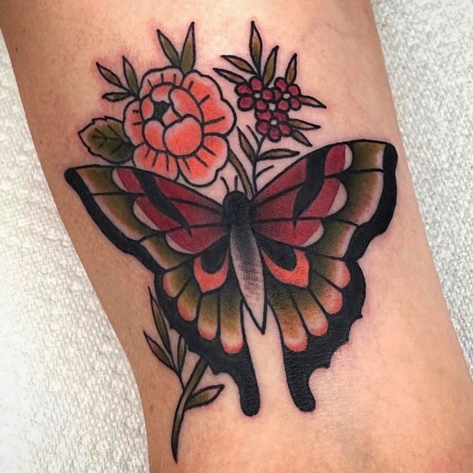 Butterfly and flowers American traditional tattoo on the forearm by Danielle Dubois
