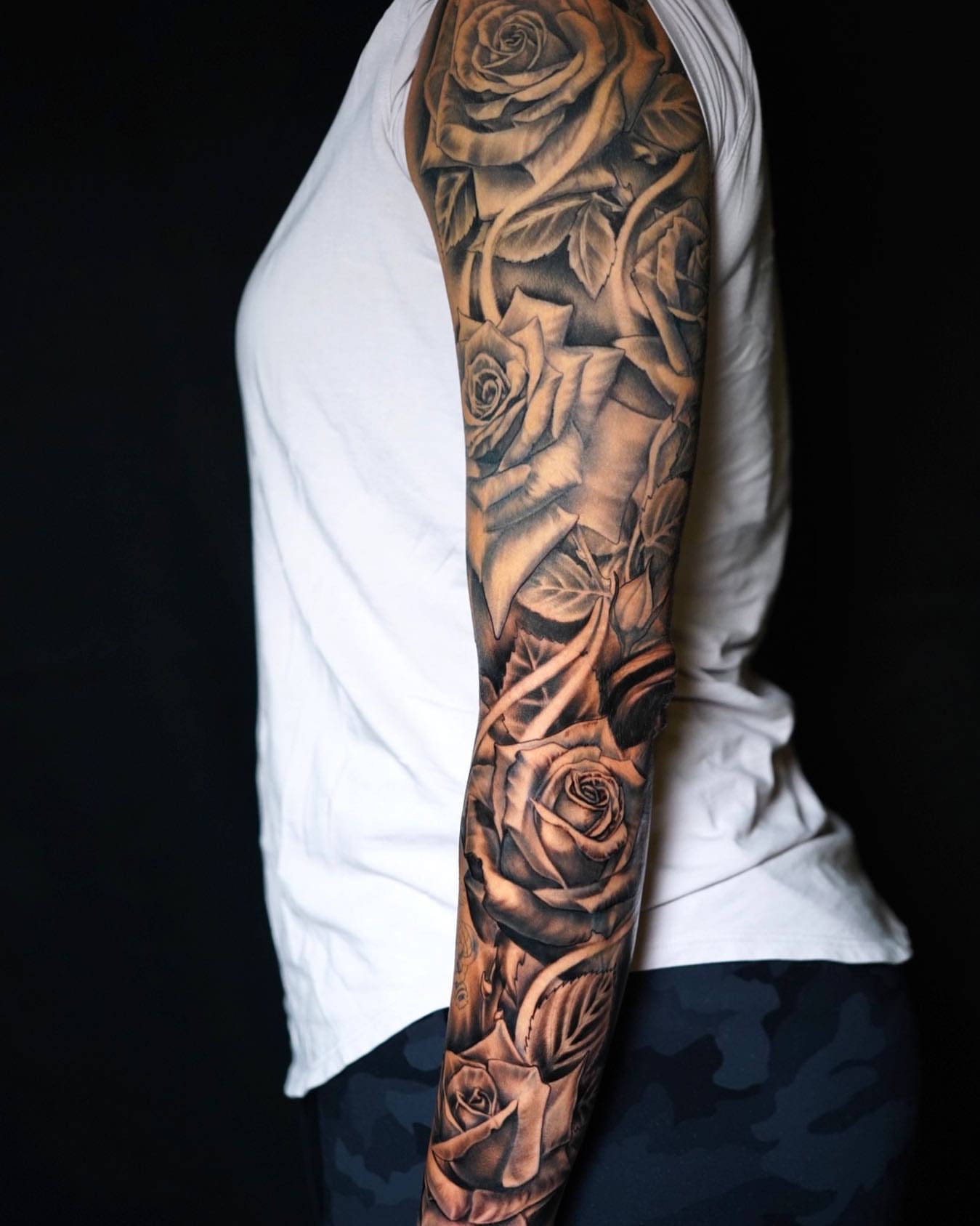 Roses realism tattoo on the upper arm by Alonzo Villa Tattoo