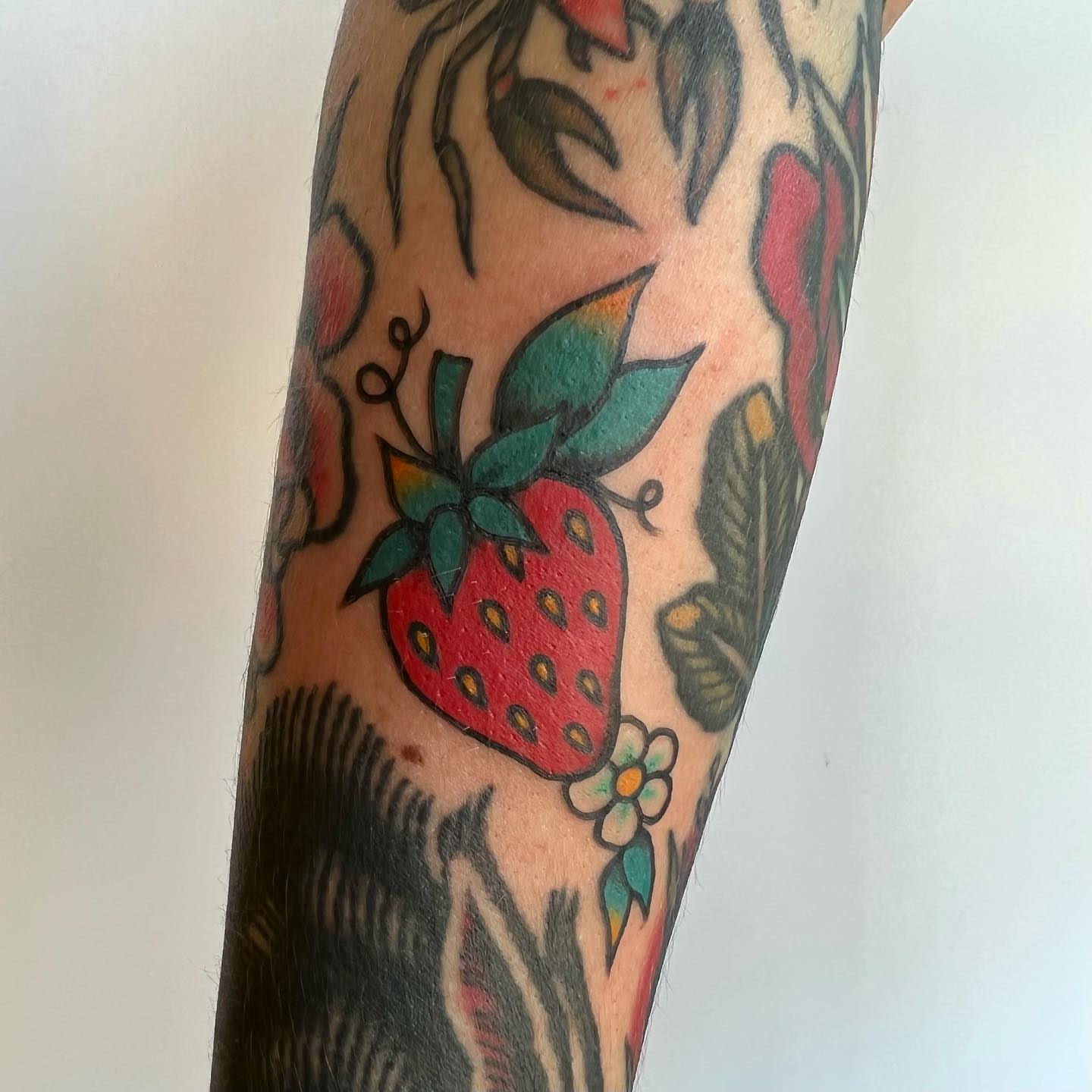 Strawberry American traditional tattoo on the forearm by 🍓miranda joon bradbury🍓