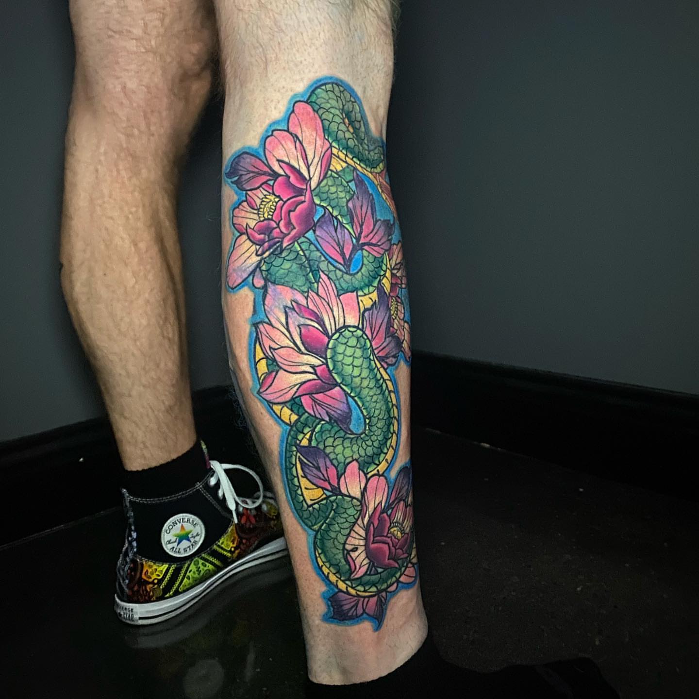 Koi fish and lotus flowers new school tattoo on the calf by Lindsey Lane, Dallas, Texas