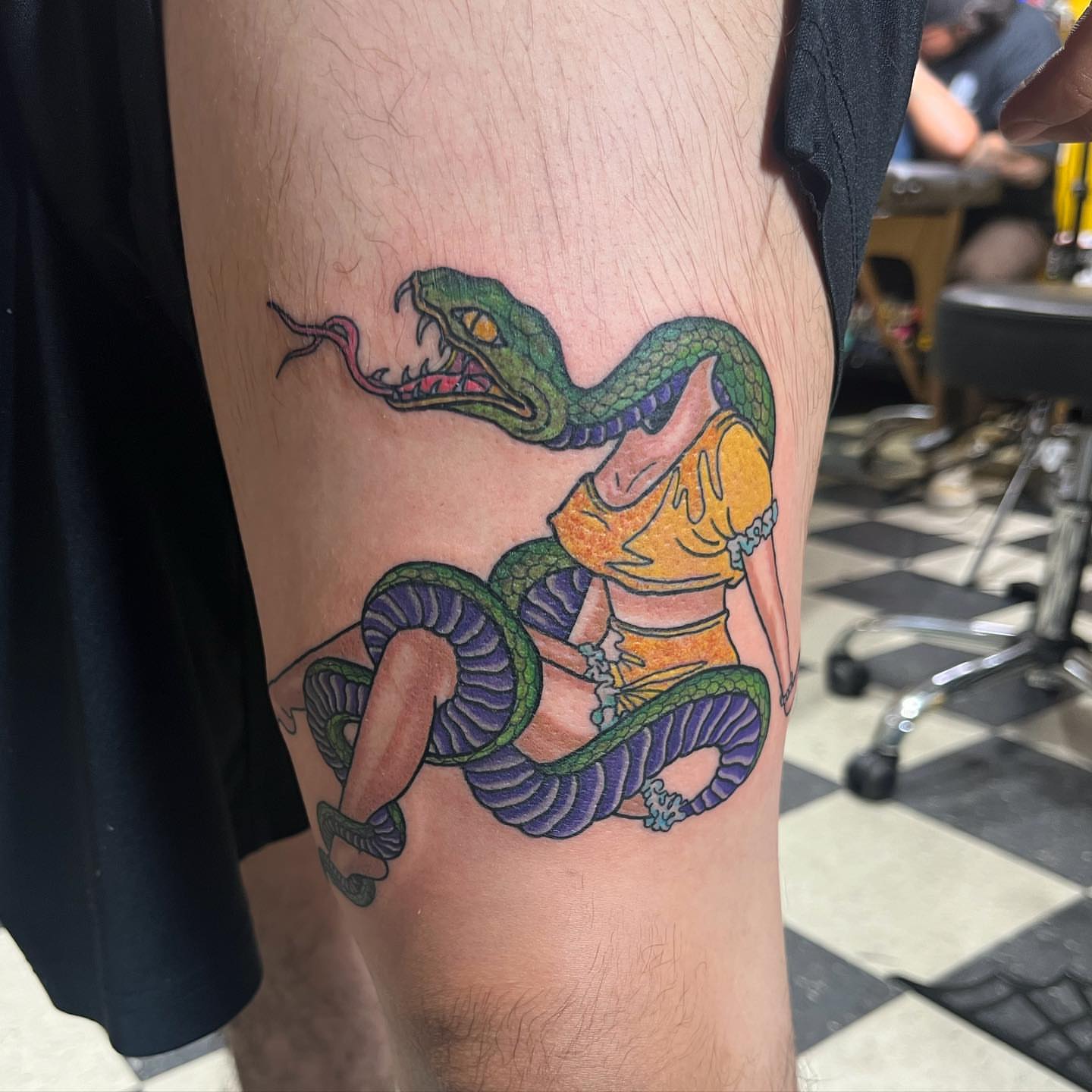 Snake and woman American traditional tattoo on the thigh by Morgan Jones