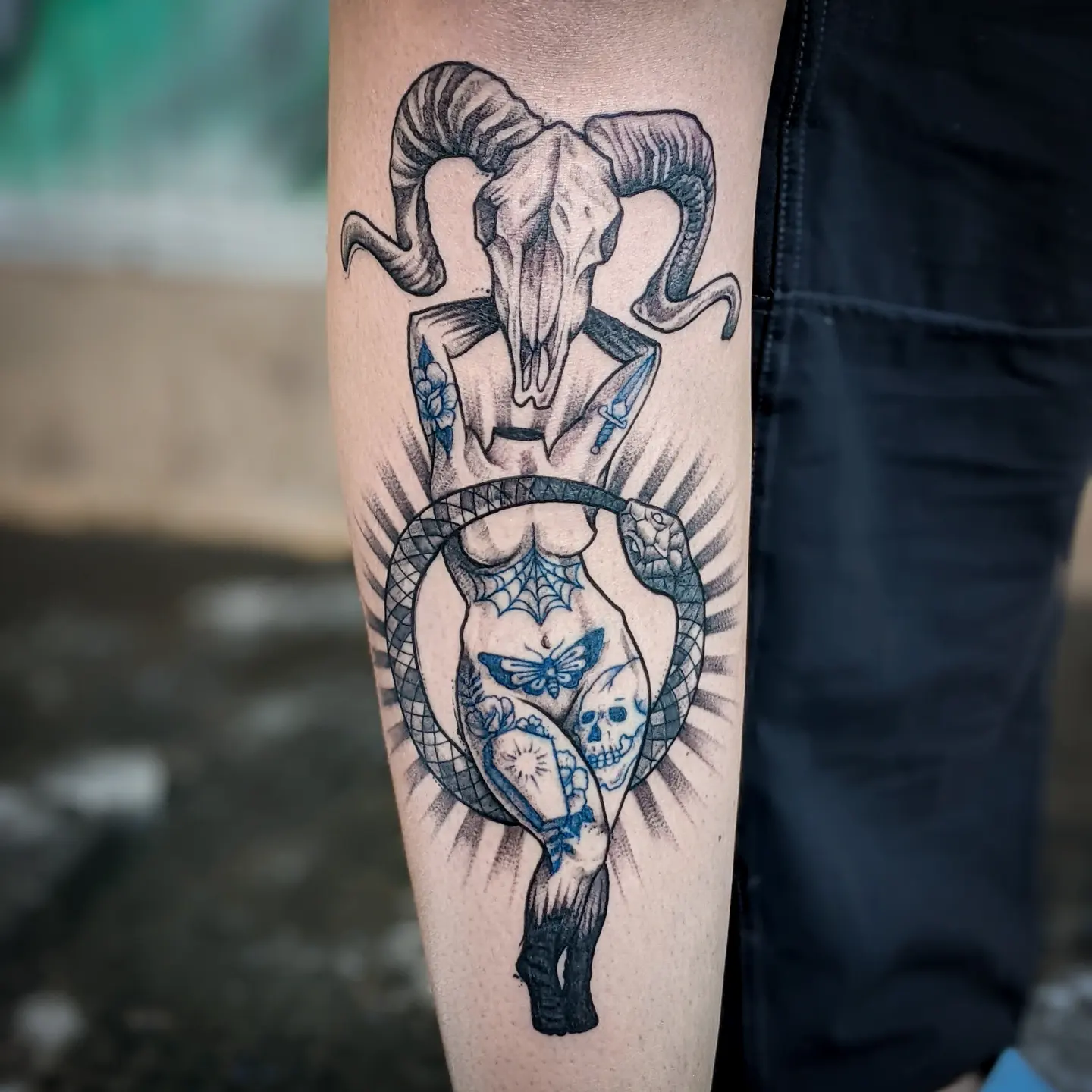 Ram skull and snake American traditional tattoo on the forearm by Gail Howard Perry III