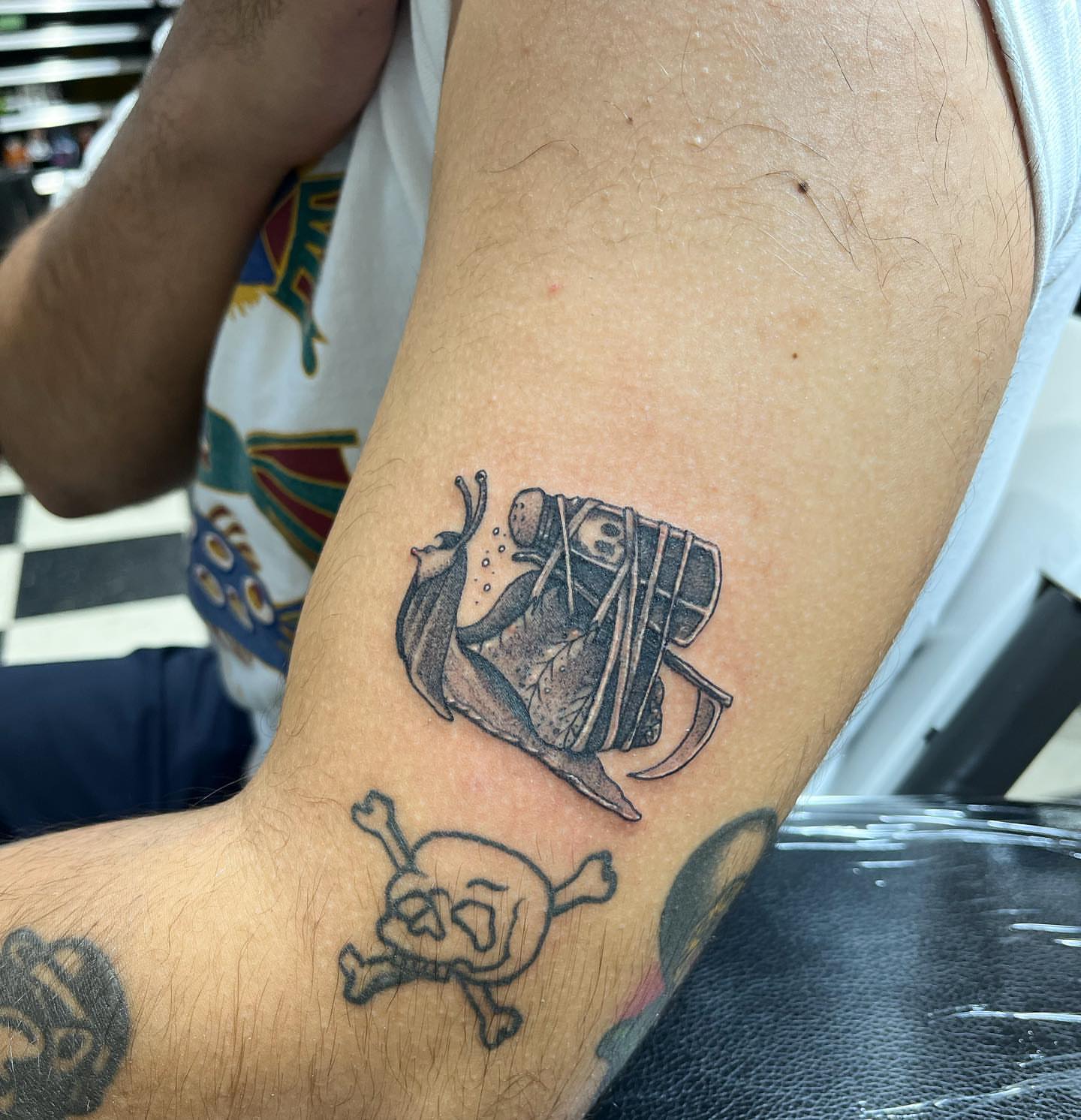 Pirate ship and skull black and grey tattoo on the forearm by Morgan Jones