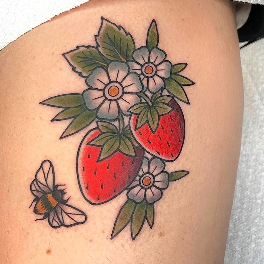 Strawberries and flowers American traditional tattoo on the thigh by Danielle Dubois