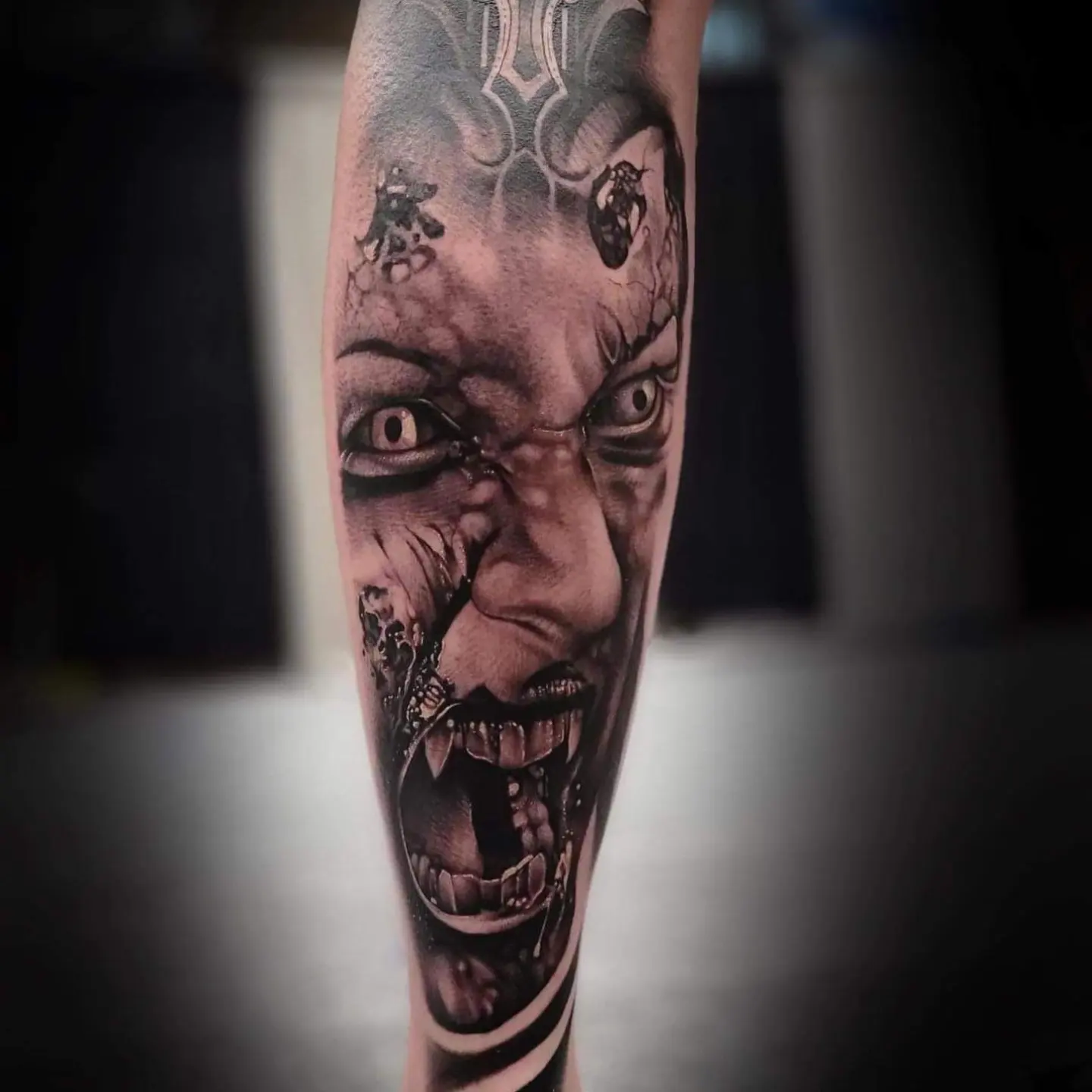 Angry face realism tattoo on the forearm by Mark Melanson