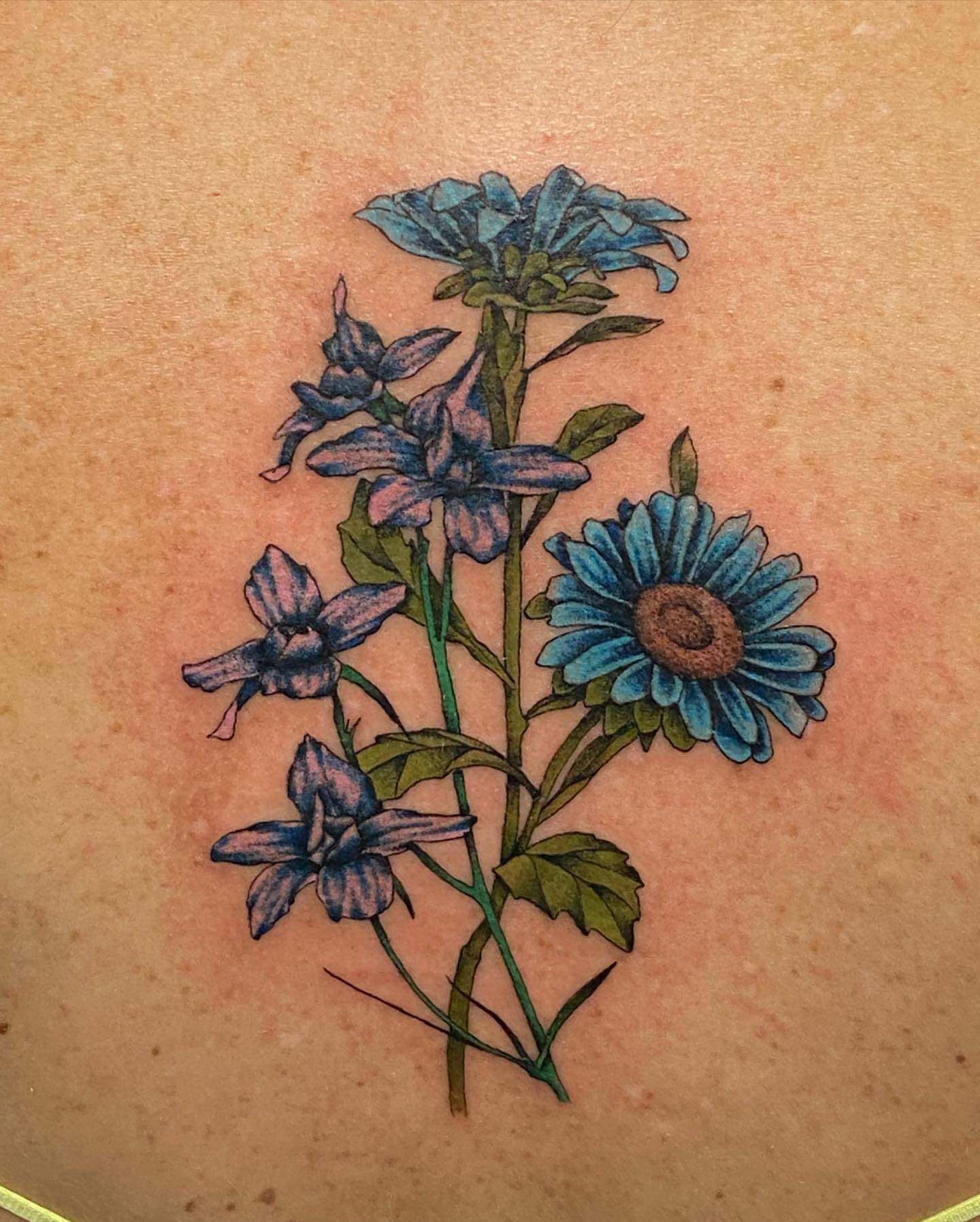 Blue flowers realism tattoo on the back by SAL, Mesa, Arizona