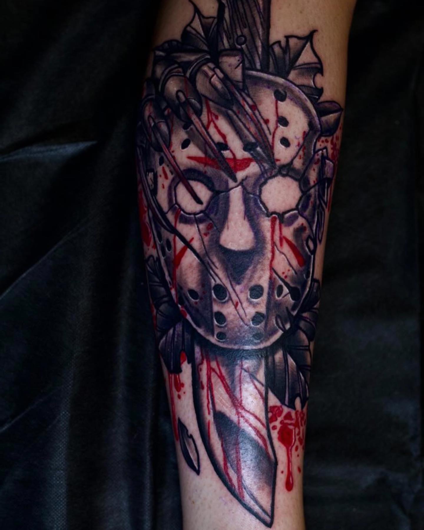 Mask with knife dark realism tattoo on the forearm by Josh St.germain