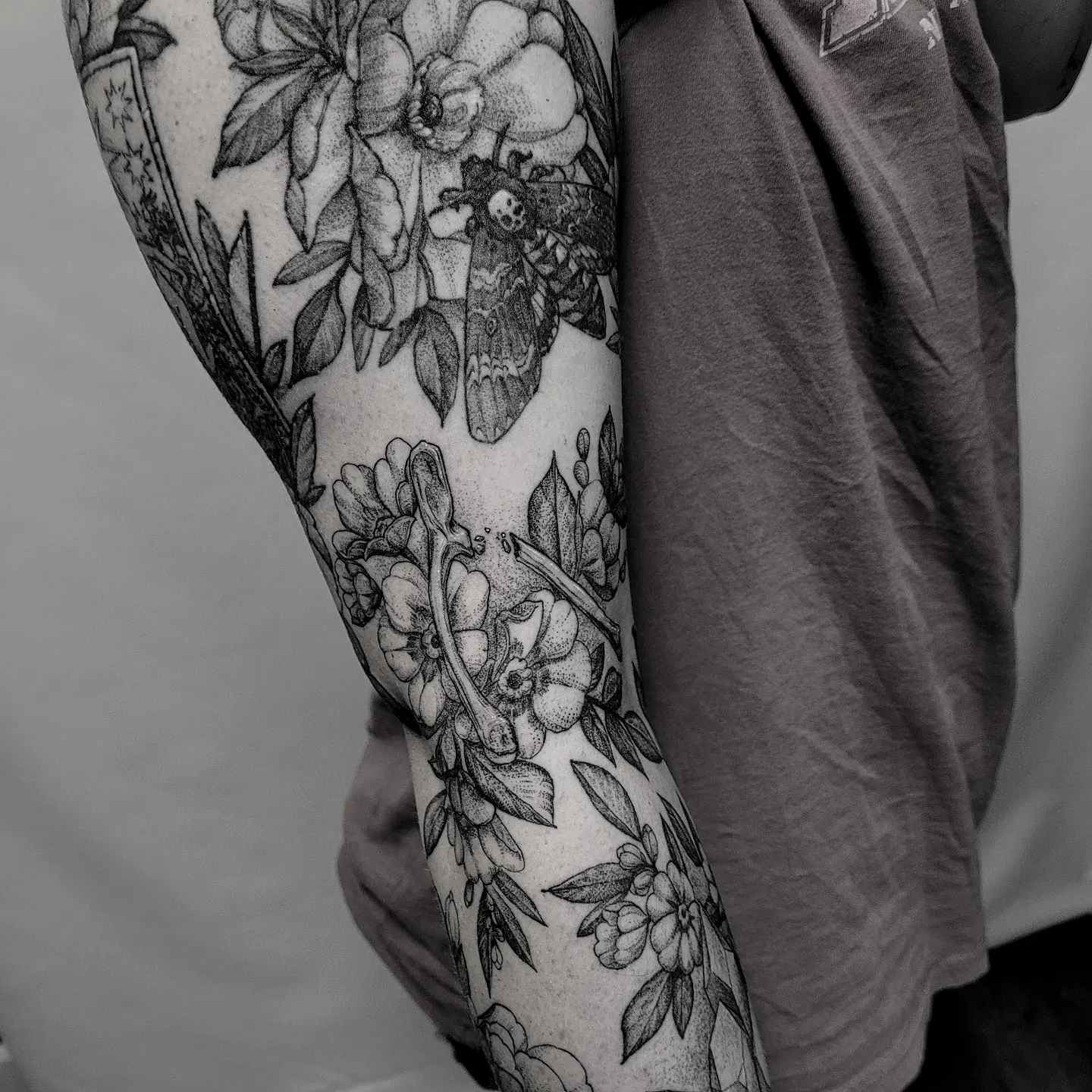 Floral moth dotwork tattoo on the forearm by Matthew Barnett