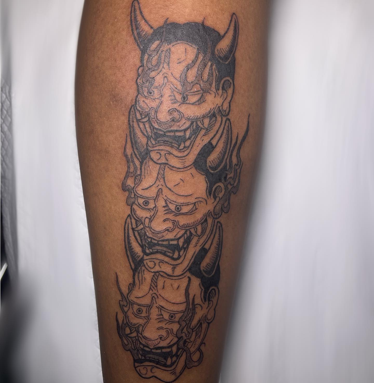 Demon heads black and grey tattoo on the leg by Shampooh