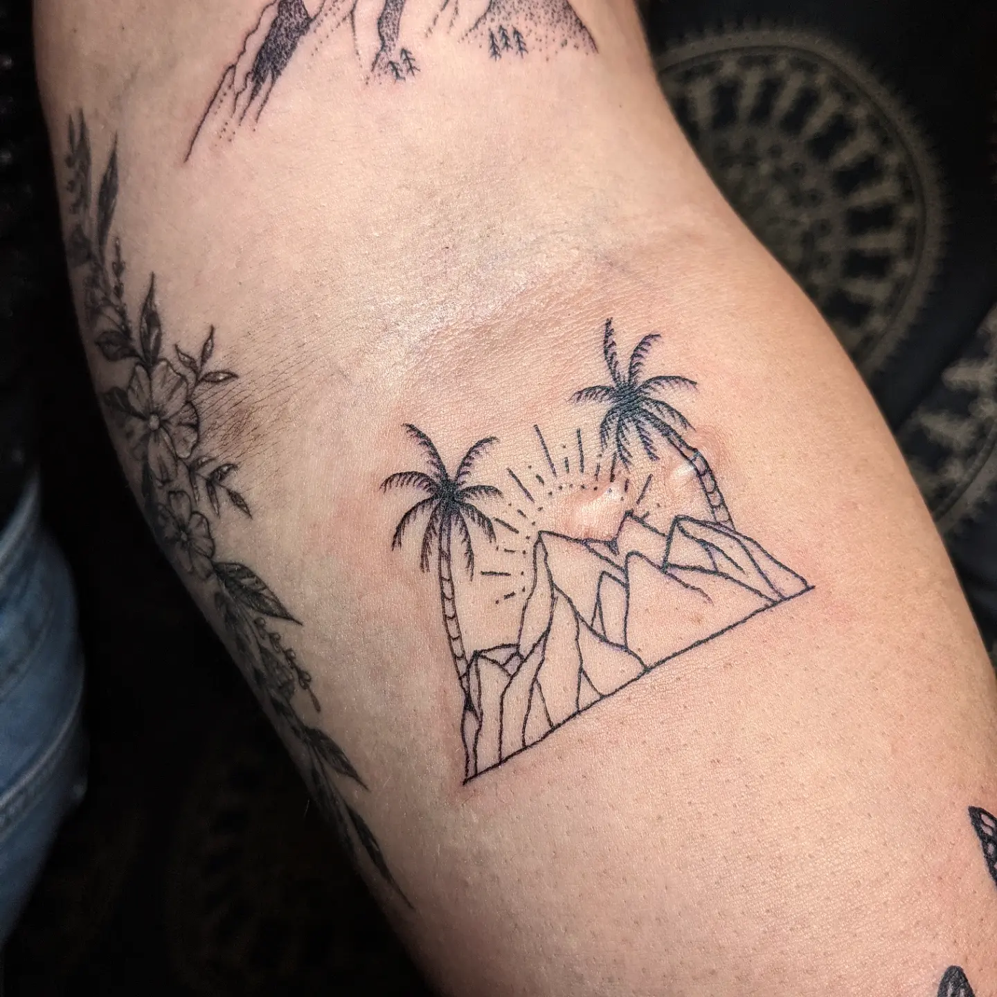 Palm trees and mountains geometric tattoo on the forearm by Aim 🤍