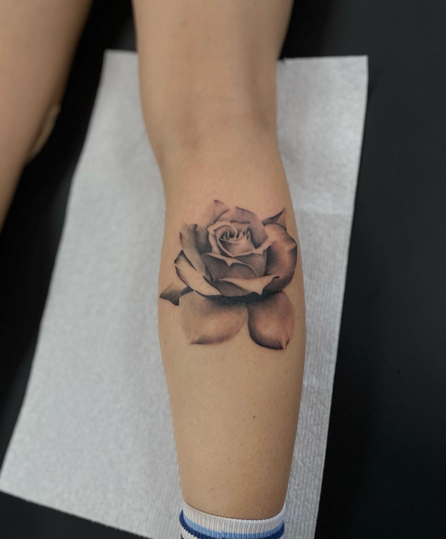 Rose black and grey tattoo on the forearm by Beans