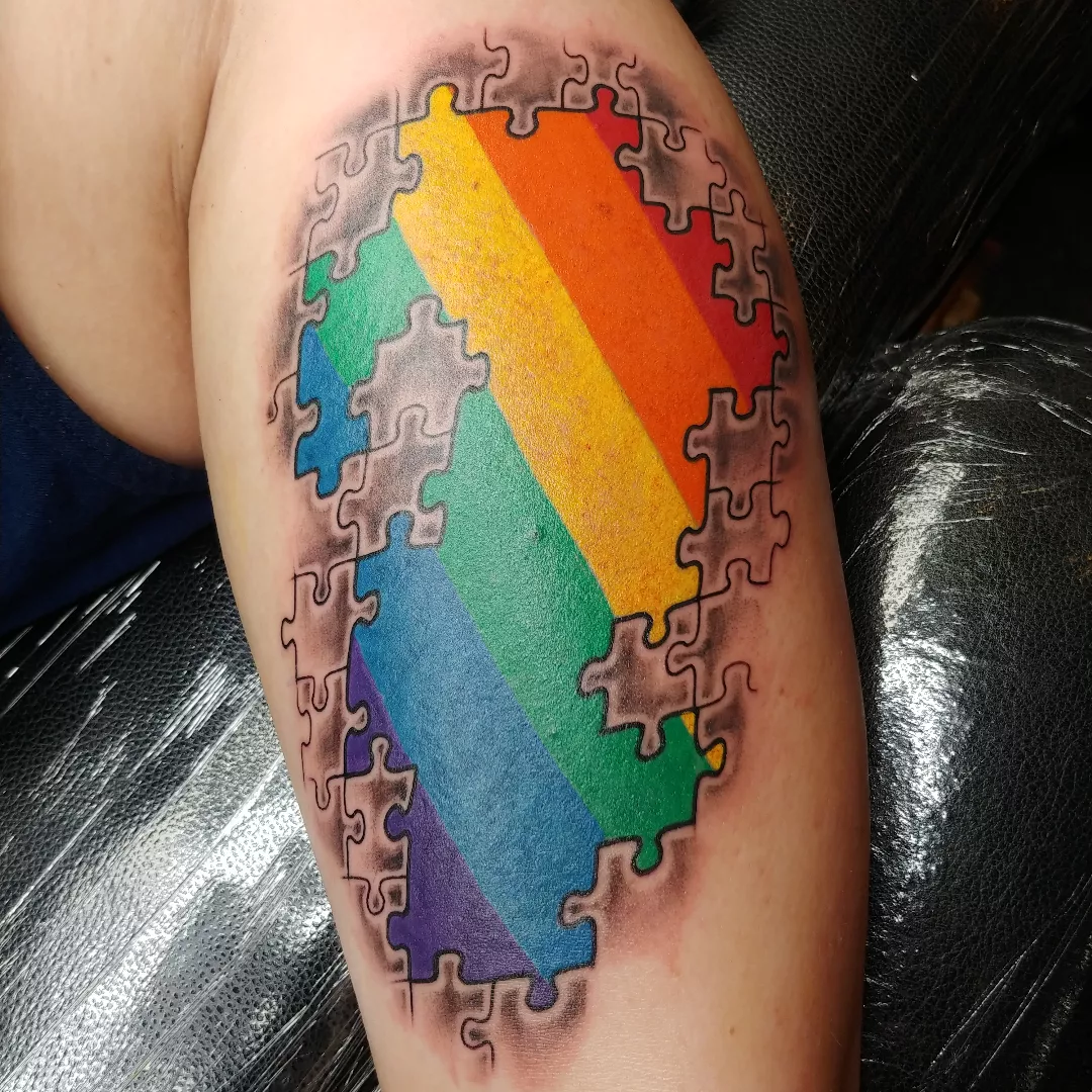 Rainbow puzzle dotwork tattoo on the forearm by CASEY JENSEN ✨ Fort Collins CO