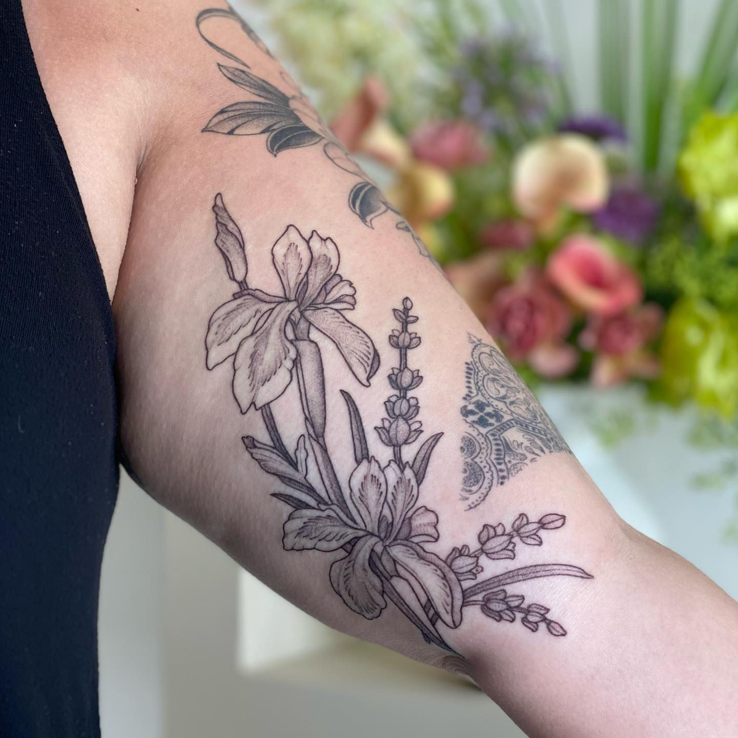 Floral arrangement black and grey tattoo on the forearm by 𝘉𝘢𝘺 𝘈𝘳𝘦𝘢 𝘛𝘢𝘵𝘵𝘰𝘰 𝘈𝘳𝘵𝘪𝘴𝘵, Oakland, California