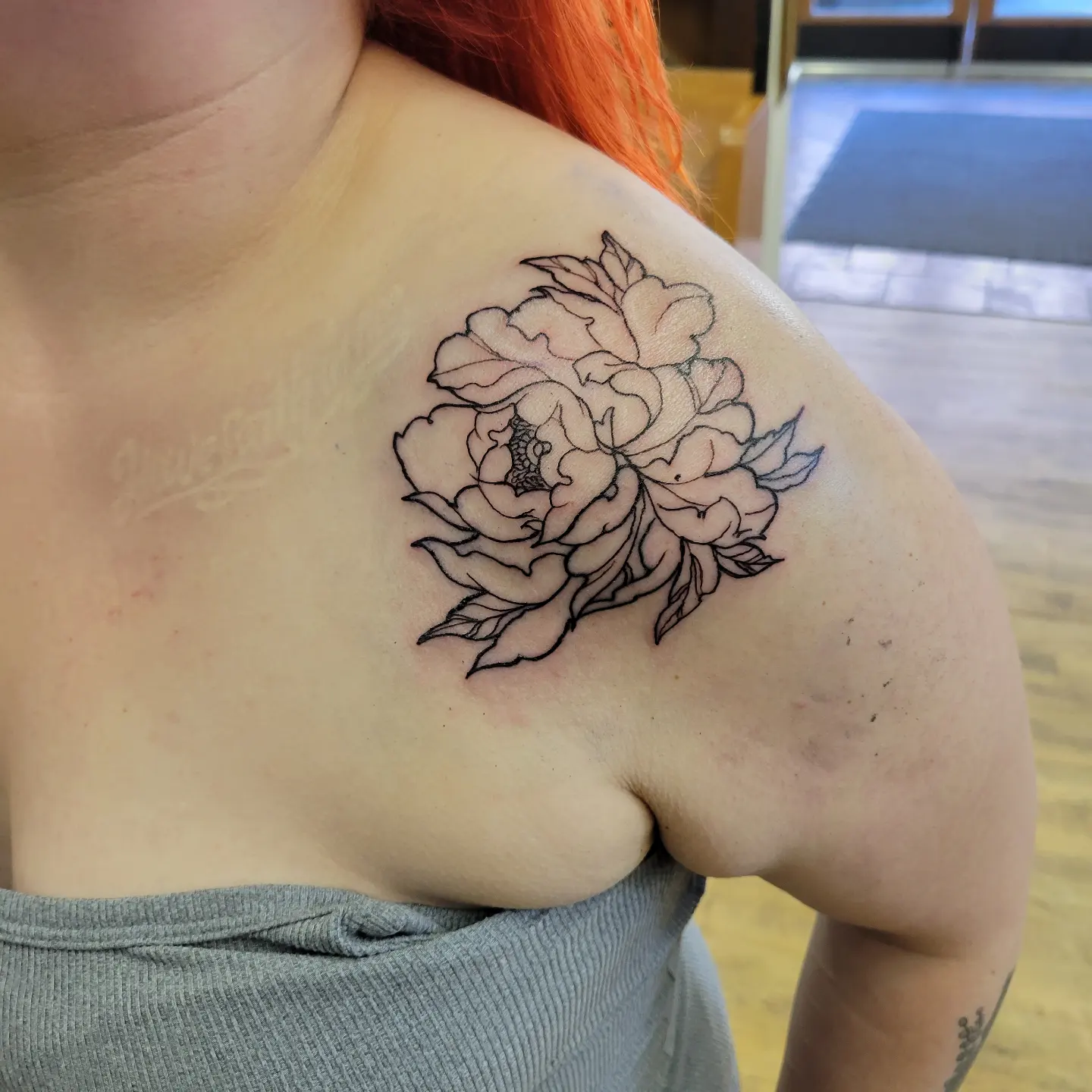 Peony bouquet black and grey tattoo on the shoulder by Tim Andrews