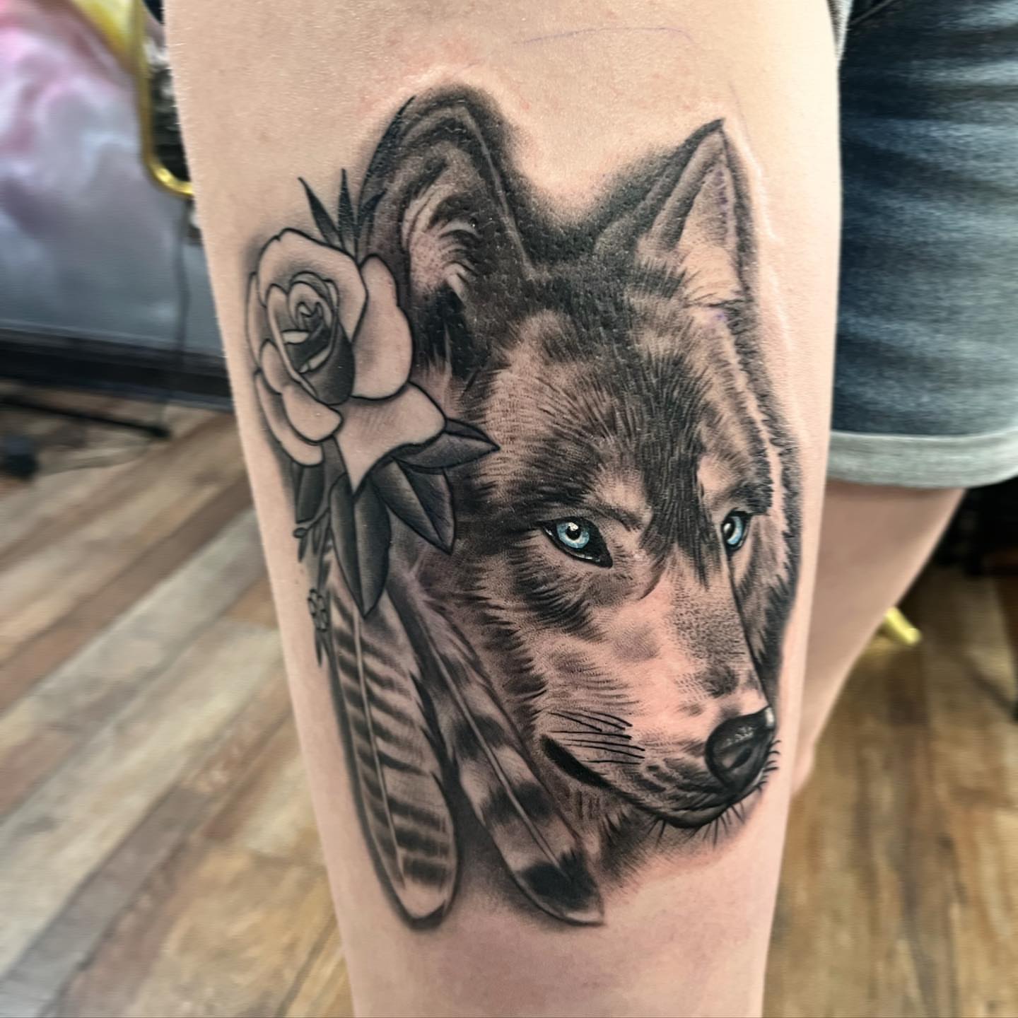 Wolf and rose realism tattoo on the thigh by Kyle hodge