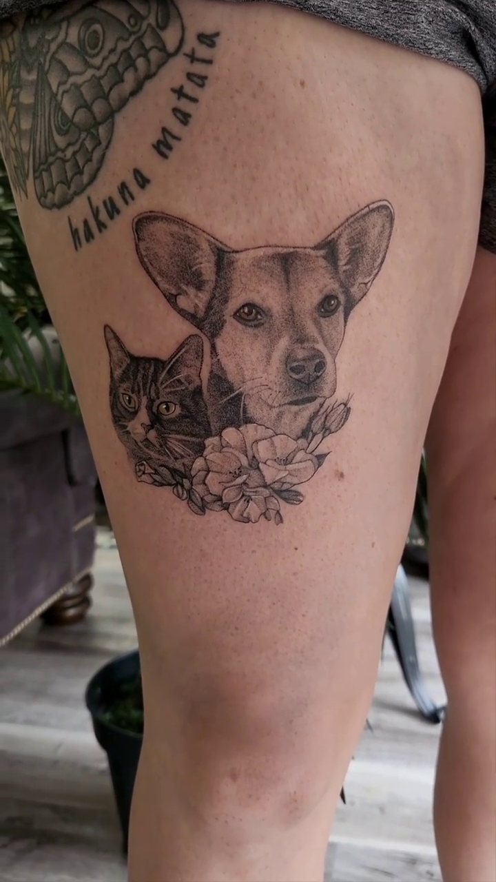 Dog and cat with flowers realism tattoo by Kyle Joseph [tattoo artist]
